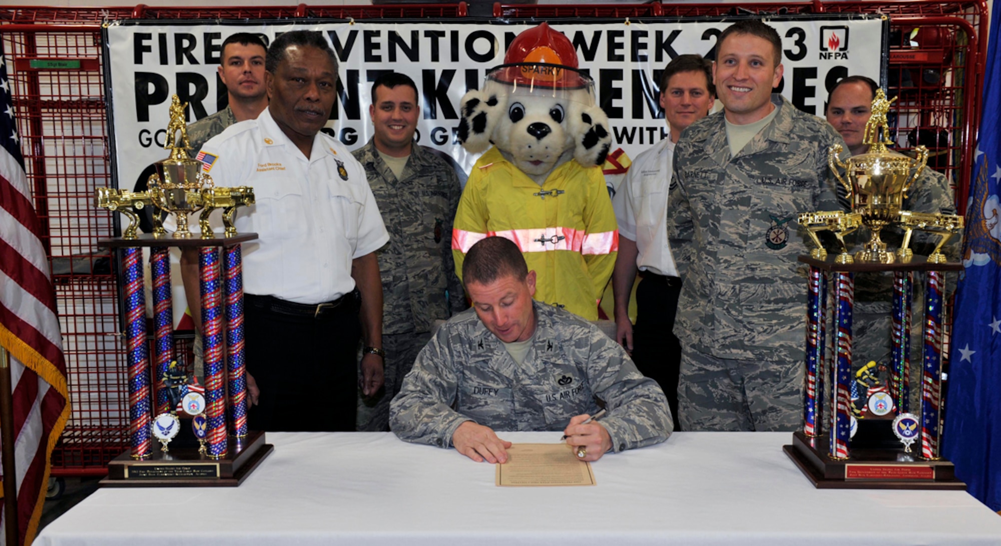 Air Force Col. Brian Duffy, 673d Air Base Wing commander, signs the annual Fire Prevention Proclamation to officially announce fire prevention week with the 673d Civil Engineeer Squadron firefighters at Fire Station 1 Sept. 24. Fire prevention week is celebrated from Oct. 6 to Oct. 12 . (U.S. Air Force photo/Airman Ty-Rico Lea)
