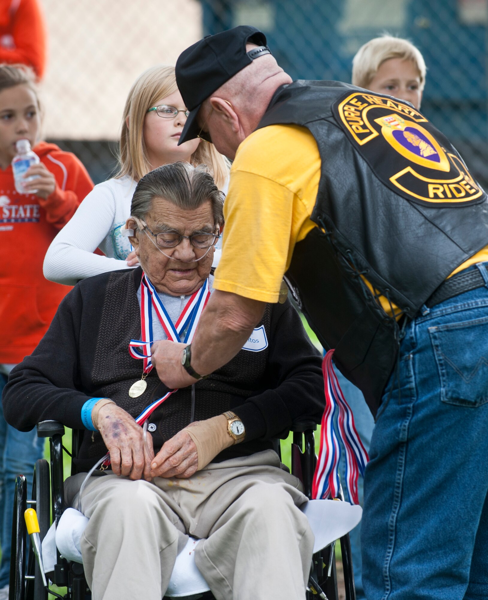 Frank Enoch receives a medal Sept. 21, 2013, at the Veterans Olympics in Boise, Idaho. Enoch was one of more than 200 veterans participating in multiple events. The top two participants for each event were given a gold or silver medal by the members of the Military Order of the Purple Heart. (U.S. Air Force Photo by Airman 1st Class Brittany A. Chase/Released) 