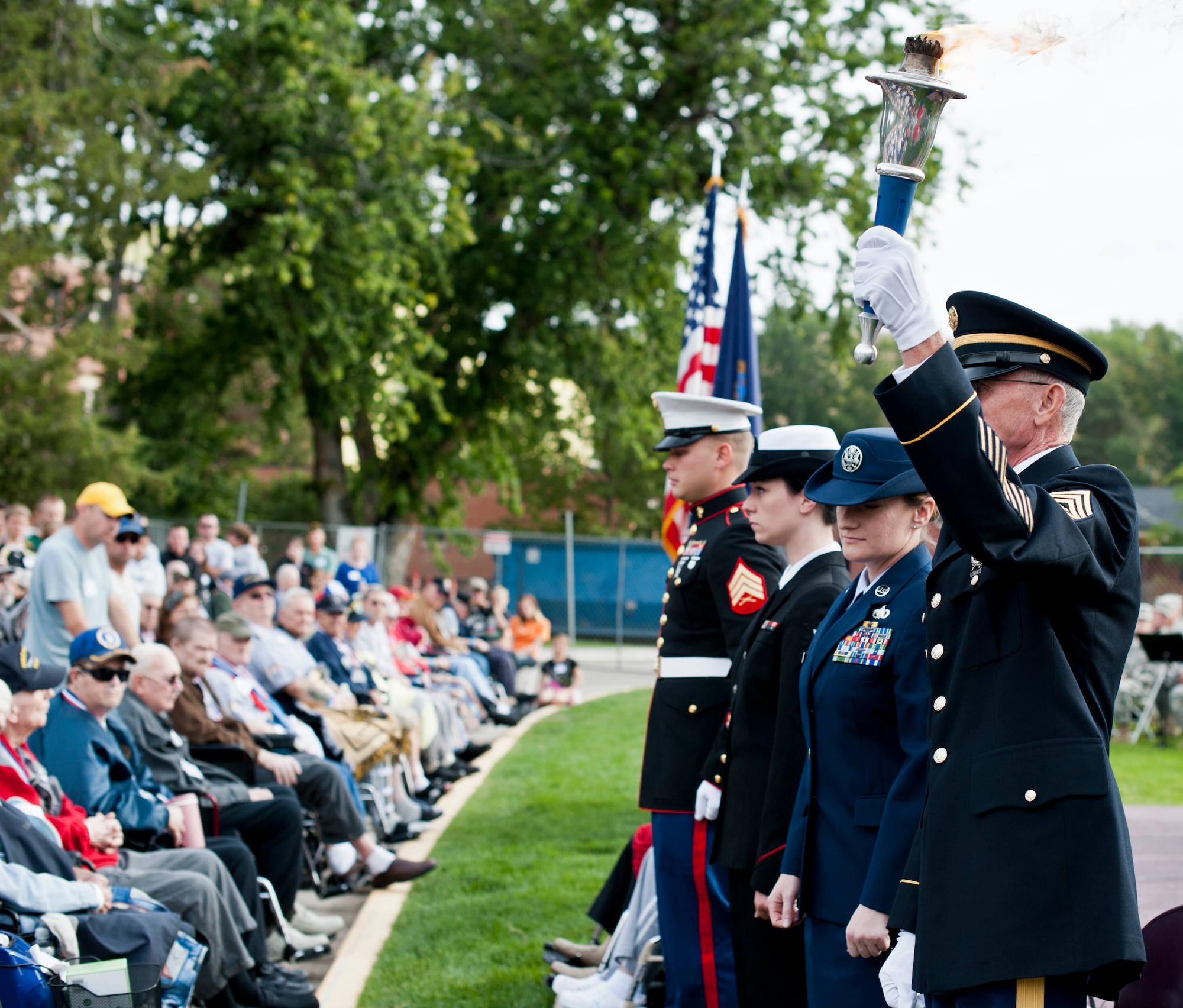 Chairman Phil Hawkins, Army retired, holds a torch Sept. 21, 2013, at the Veterans Olympics in Boise, Idaho. A representative from the Marines, Navy, Air Force and Army passed a torch at the beginning of the event signifying those who served and continue to serve in the U.S. armed forces. (U.S. Air Force Photo by Airman 1st Class Brittany A. Chase/Released)