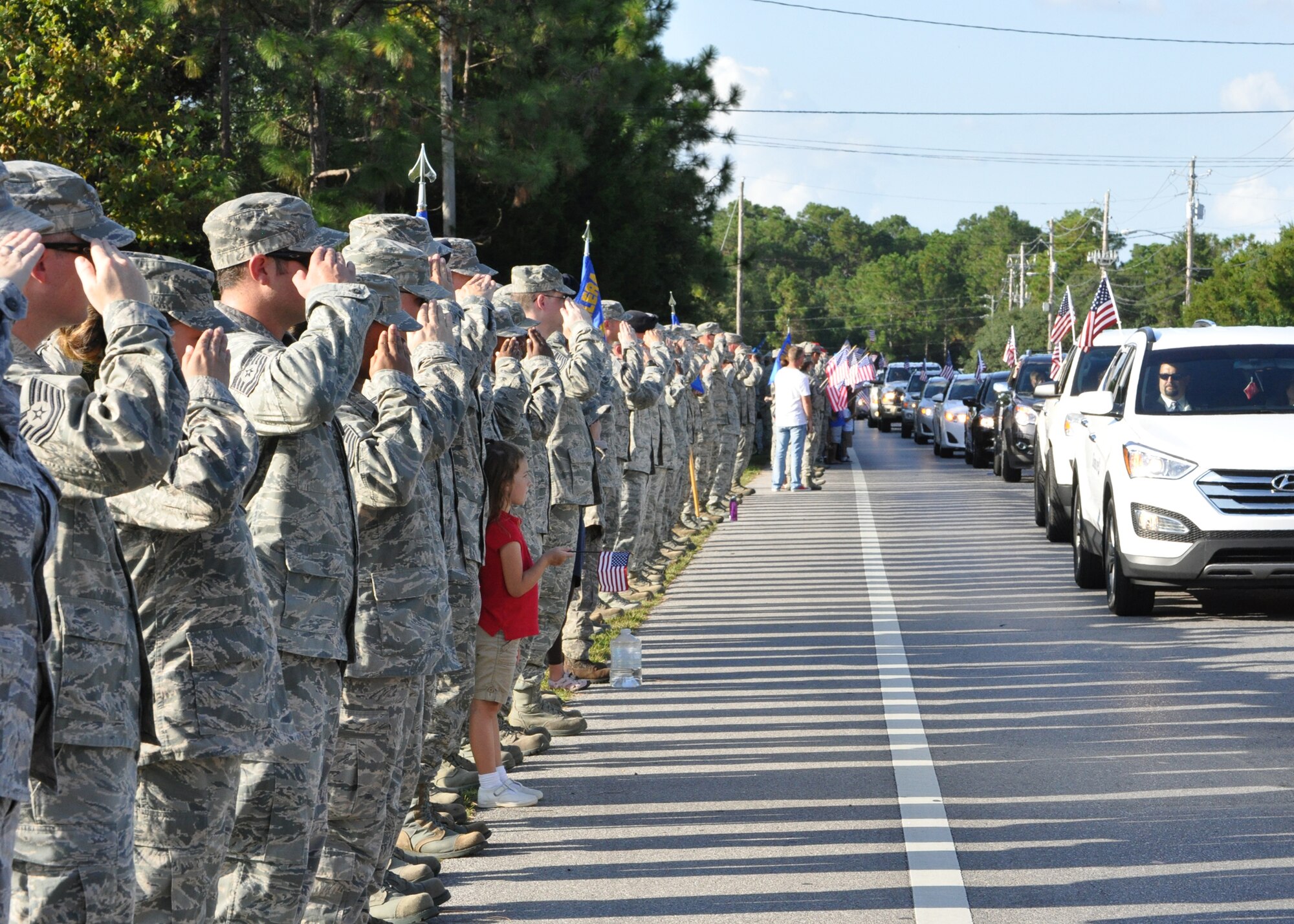 Tyndall Airmen salute the wounded warriors as they pass Sept. 19 along the parade route as a part of the Warrior Beach Retreat program. The program brings wounded warriors and their spouse or caregiver to Panama City Beach for a week of rest and relaxation. (U.S. Air Force photo by Ashley Wright)
