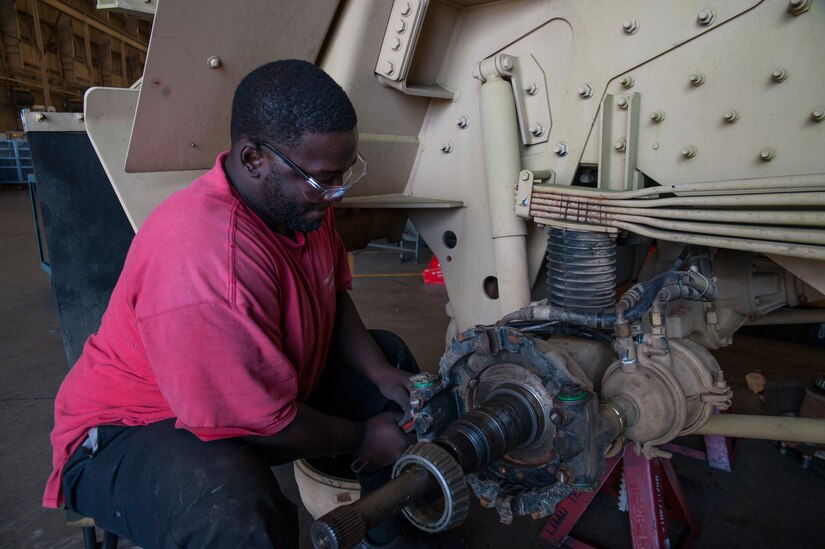 Samuel Richard, Army Strategic Logistics Activity Charleston mechanic level II, works on an Army tactical vehicle Sept. 24, 2013, at Joint Base Charleston - Weapons Station, S.C.  ASLAC provides the U.S. warfighter the ability to quickly generate combat power at any location designated by the National Command Authority by establishing, maintaining and reconstituting Army Prepositioned Stocks Afloat. (U.S. Air Force photo/Senior Airman Ashlee Galloway)