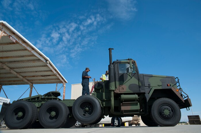 Dean Ramnarine, Army Strategic Logistics Activity Charleston quality assurance specialist and Tony Joyner, quality control inspector, inspect an Army tactical vehicle Sept. 24, 2013, at Joint Base Charleston - Weapons Station, S.C.  ASLAC provides the U.S. warfighter the ability to quickly generate combat power at any location designated by the National Command Authority by establishing, maintaining and reconstituting Army Prepositioned Stocks Afloat. (U.S. Air Force photo/Senior Airman Ashlee Galloway)