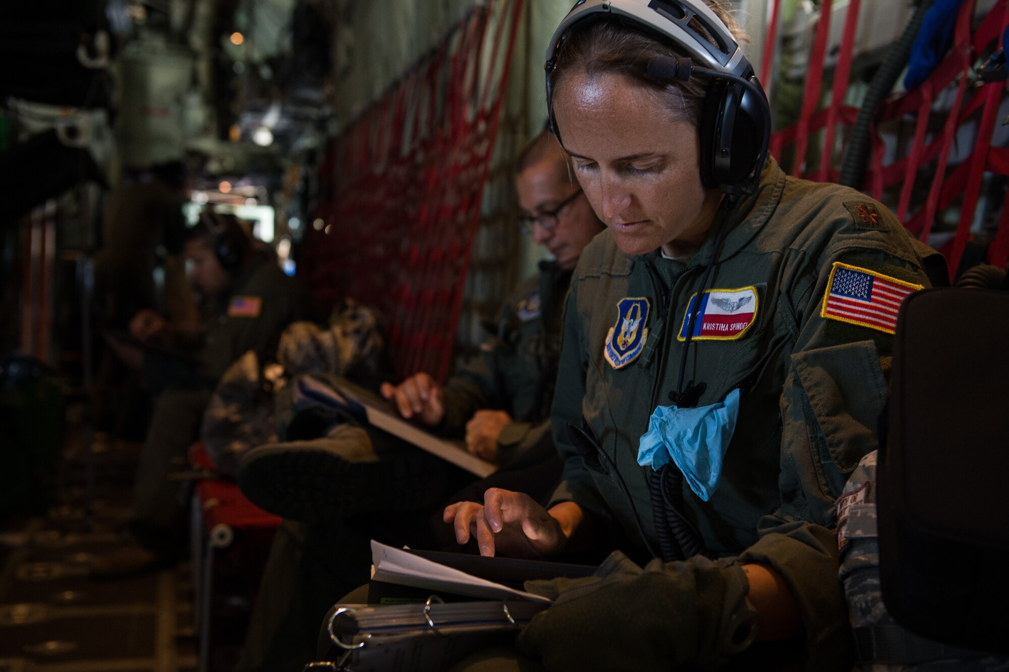 Air Force Reserve Maj. Kristina Spindel, 433rd Aeromedical Evacuation Squadron flight nurse, reviews a patient's paperwork on a WC-130J Hurricane Hunter during an aeromedical evacuation training mission at Joint Base San Antonio-Lackland, Texas, Sept. 19, 2013. The training allowed 433rd AES members to set up litter systems in conjunction with the aircraft's configuration, practice caring for patients in-flight and simulate in-flight emergency procedures.  (U.S. Air Force photo/Staff Sgt. Jonathan Snyder)

