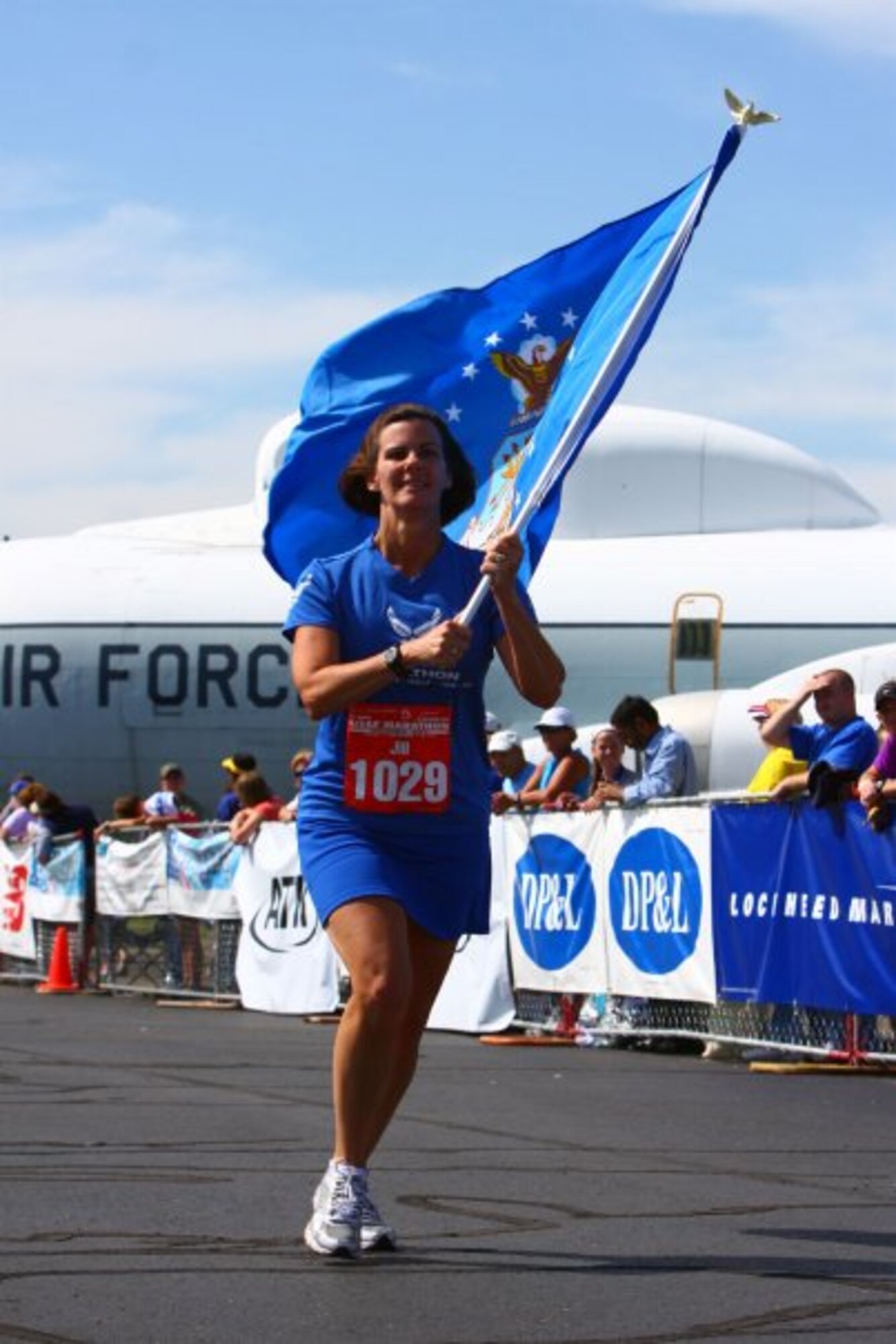 Col. Jill Higgins, Air Force Global Strike Command, personnel division chief, runs the Air Force Marathon while holding the Air Force flag in Dayton, Ohio, May 20, 2009. Higgins has competed in more than 10 marathons throughout her life. (Courtesy Photo)
