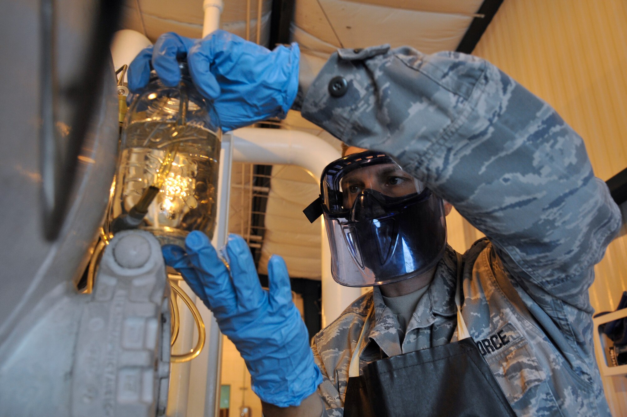 Tech. Sgt. Ronald Gasper measures fuel into a jar during a sample collection Sept. 17, 2013, Scott Air Force Base, Ill. This test ensures the fuels transfer point is filtering out water and particulates entrained in the fuel. Gasper is the noncommissioned officer in charge of the fuels laboratory assigned to the 375 Logistics Readiness Squadron. (U.S. Air Force photo/Staff Sgt. Christopher Boitz)