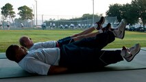 Air Force Reserve Tech. Sgt. Tremain Strong, left, and Senior  Master Sgt. David Parcher, from the 919th Maintenance Squadron, perform flutter kicks during a unit physical training session at Duke Field, Fla., Sept. 7.  The squadron begins each monthly unit training assembly with a mass stretching and calisthenics session before releasing members to finish individual workouts such as running, weight training, basketball, volleyball and more. (U.S. Air Force photo/Tech. Sgt. Jasmin Taylor) 