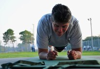 Air Force Reserve Senior Master Sgt. Annie Reid, the 919th Maintenance Squadron first sergeant, performs planks during one of her unit's physical training sessions at Duke Field, Fla., Sept. 7.   The squadron begins each monthly unit training assembly with a mass stretching and calisthenics session before releasing members to finish individual workouts such as running, weight training, basketball, volleyball and more. (U.S. Air Force photo/Tech. Sgt. Jasmin Taylor) 