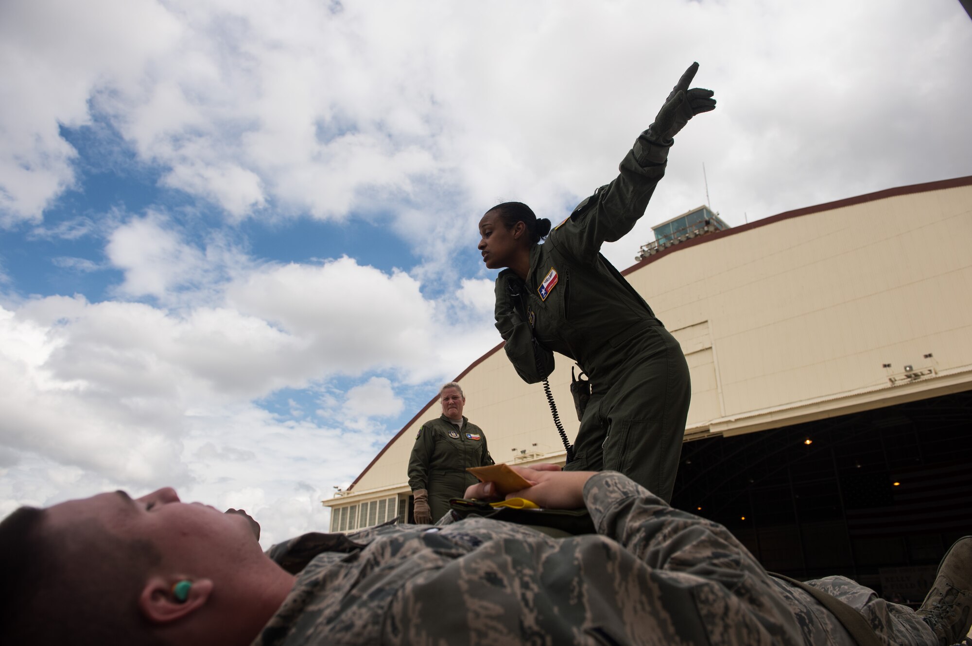 Air Force Reserve Senior Airman Chemika Lynch, 433rd Aeromedical Evacuation Squadron emergency medical technician, talks to patients prior to boarding a WC-130J Hurricane Hunter during a aeromedical evacuation training mission at Joint Base San Antonio-Lackland, Texas, Sept. 19, 2013. The training allowed 433rd AES members to set up litter systems in conjunction with the aircraft's configuration, practice caring for patients in flight and simulate in-flight emergency procedures.  (U.S. Air Force photo/Staff Sgt. Jonathan Snyder)
