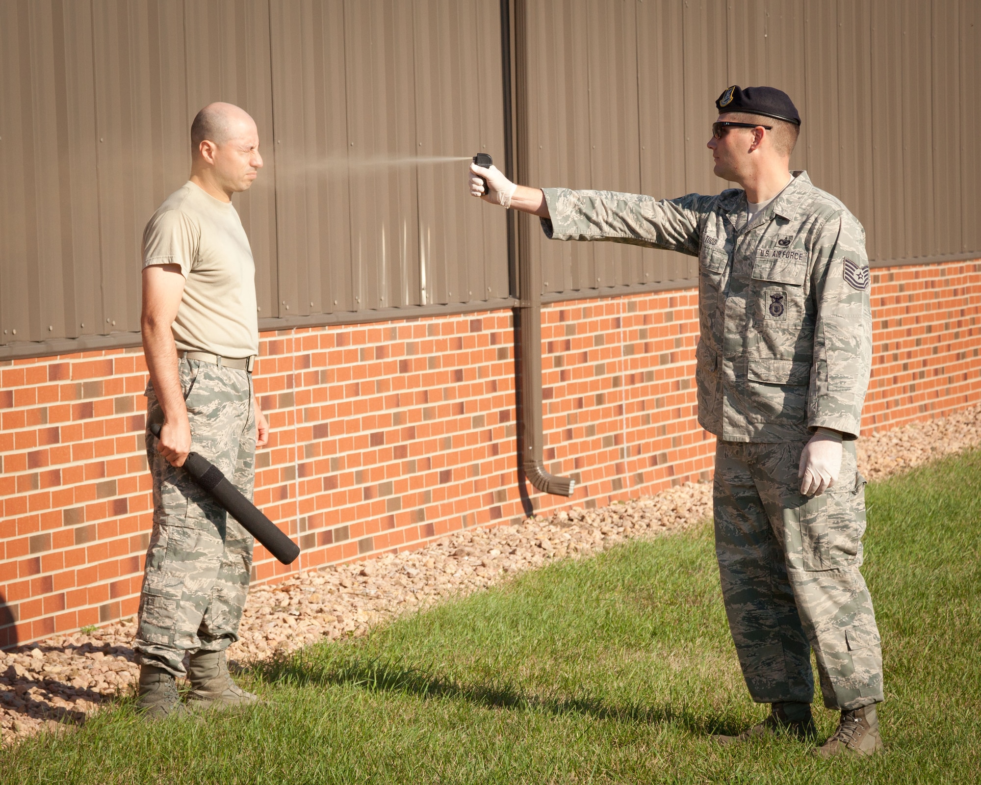 Staff Sgt. Luis Lechuga, 934th Security Forces Squadron, is sprayed with pepper spray by Tech. Sgt. Jesse Todd, 133 SFS, during a training exercise at the Minneapolis-St. Paul Air Reserve Station, Minn.  (U.S. Air Force photo/Shannon McKay)