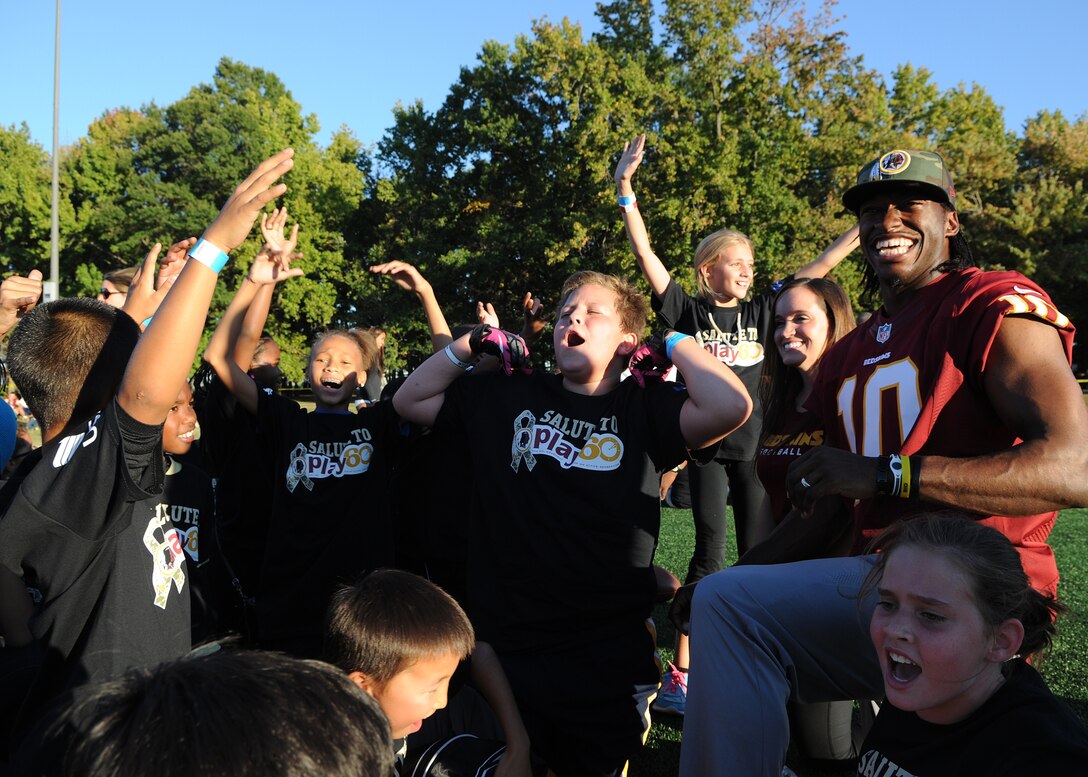 Children sound-off in support of their trainer Washington Redskins quarterback Robert Griffin III during the Salute to Play 60 Military Challenge at Joint Base Andrews, Md., Sept. 24, 2013. During the event Redskins players and celebrity trainers lead the children through stations that included passing drills, agility ladders, 40-yard dash and a lesson on health eating habits. (U.S. Air Force photo/ Airman 1st Class Nesha Humes)
