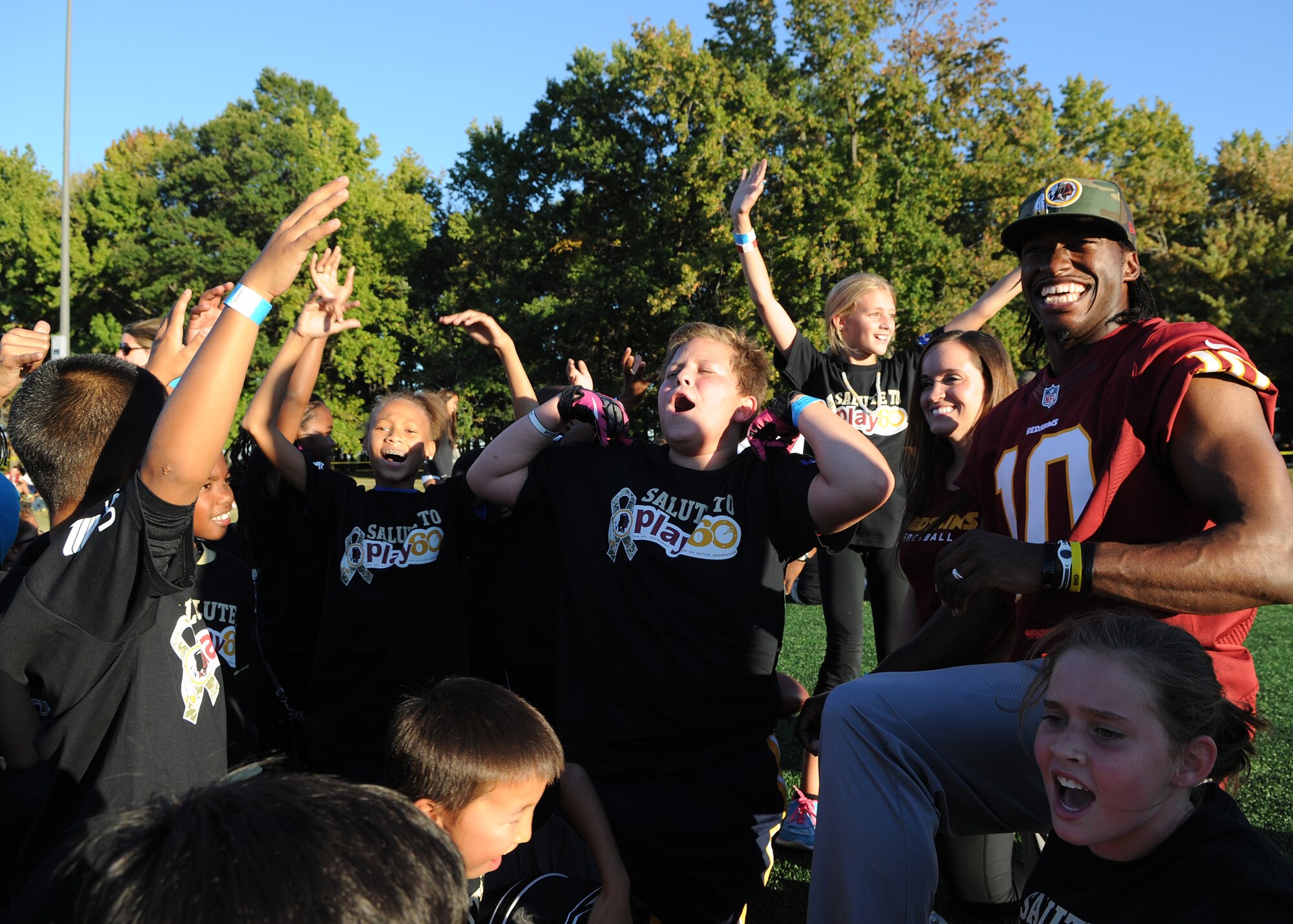 Children sound-off in support of their trainer Washington Redskins quarterback Robert Griffin III during the Salute to Play 60 Military Challenge at Joint Base Andrews, Md., Sept. 24, 2013. During the event Redskins players and celebrity trainers lead the children through stations that included passing drills, agility ladders, 40-yard dash and a lesson on health eating habits. (U.S. Air Force photo/ Airman 1st Class Nesha Humes)
