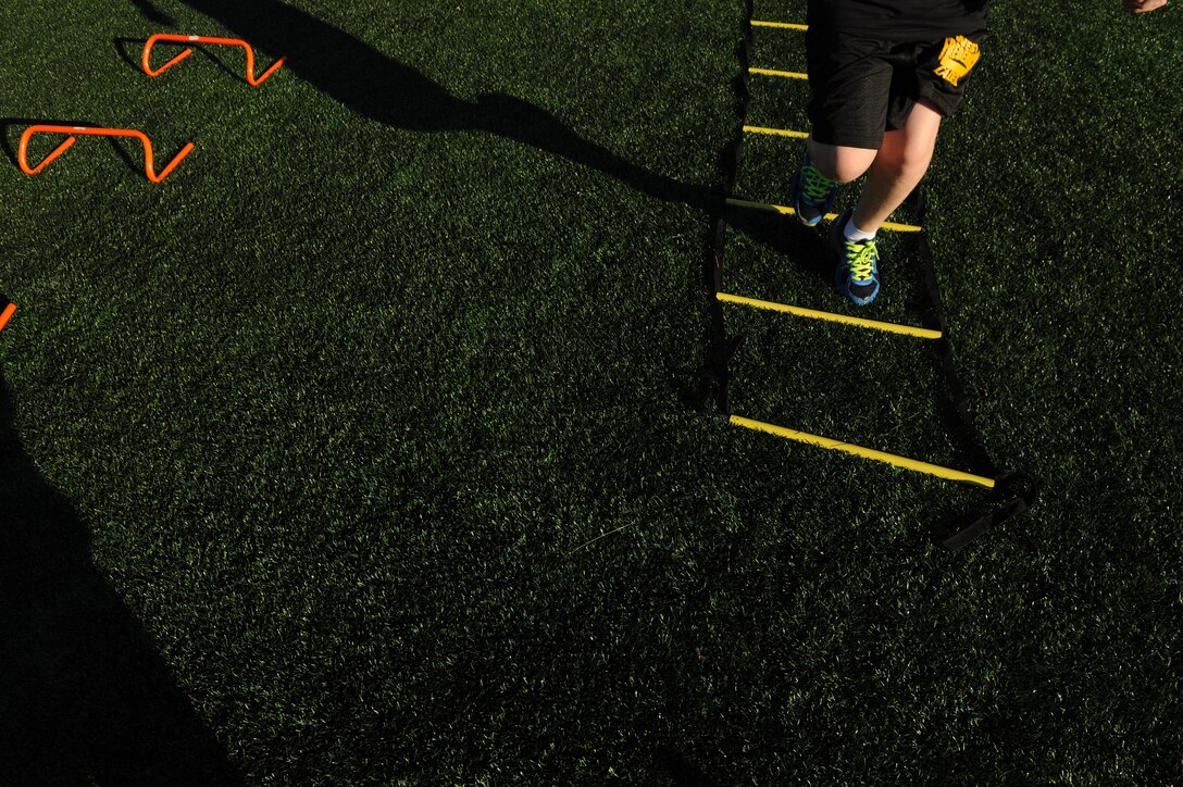 A child completes the agility ladder during the Salute to Play 60 Military Challenge at Joint Base Andrews, Md., Sept. 24, 2013. The initiative is part of the National Football League’s larger Play 60 campaign, which is designed to encourage kids to be active for 60 minutes a day to help reverse the trend of childhood obesity. (U.S. Air Force photo/ Airman 1st Class Nesha Humes)