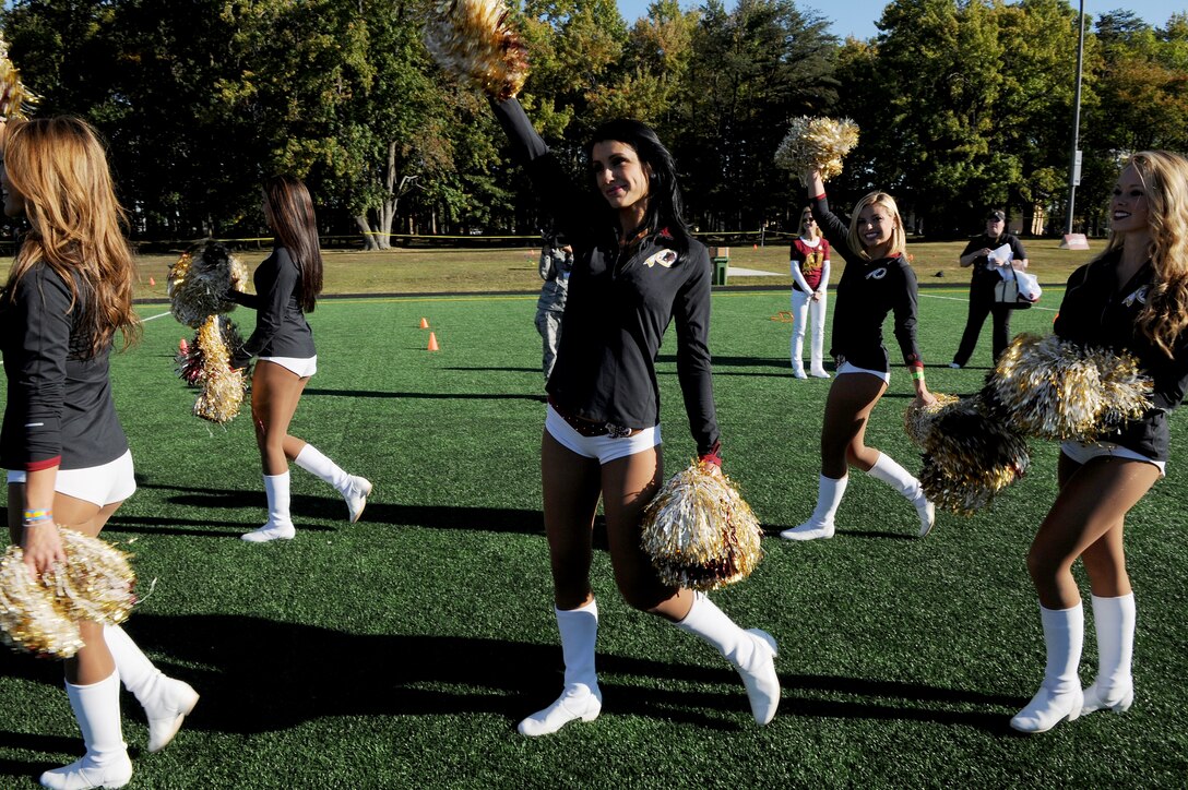 Washington Redskins Cheerleaders rally the crowd during the Salute to Play 60 Military Challenge at Joint Base Andrews, Md., Sept. 24, 2013.  The initiative is part of the National Football League’s larger Play 60 campaign, which is designed to encourage kids to be active for 60 minutes a day to help reverse the trend of childhood obesity. (U.S. Air Force photo/ Airman 1st Class Nesha Humes)