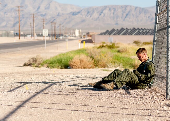 The pilot of a simulated downed aircraft waits for medical attention Sept. 19, 2013, near the Mike O’ Callaghan Federal Medical Center during a an aircraft crash response exercise at Nellis Air Force Base, Nev.  First responders were responsible for diverting traffic, putting out simulated fires, rescuing people, assessing damage and providing medical attention to simulated injured people during the exercise. (U.S. Air Force photo by Staff Sgt. Michael Charles) 