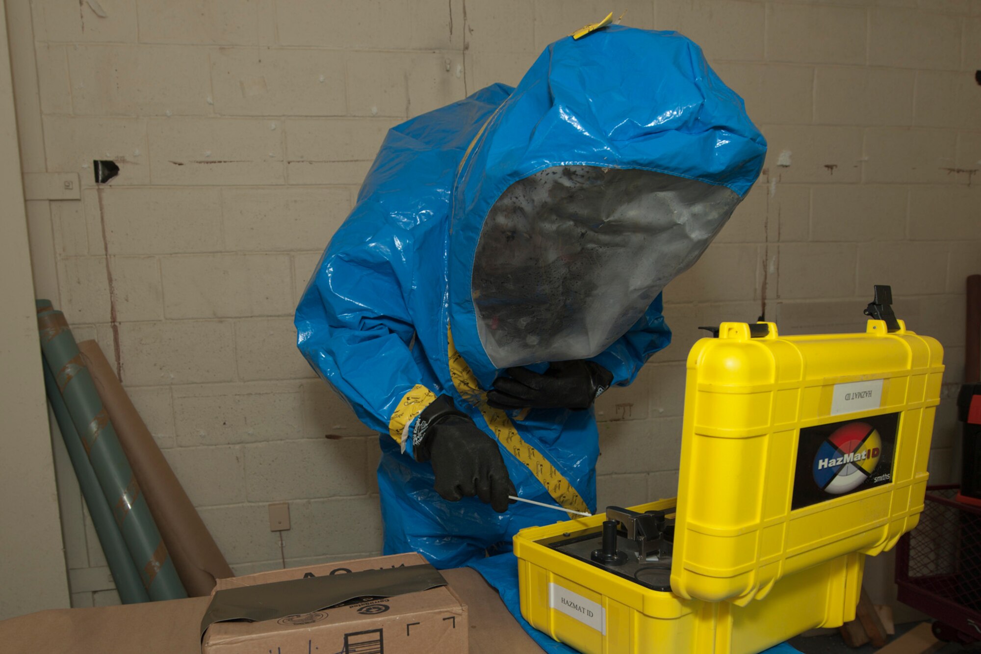 U.S. Air Force Staff Sgt. Samuel Helfrich, 65th Civil Engineer Squadron emergency management technician, uses the HazMat ID to test a powder substance for simulated hazardous material during a joint biological response training exercise Sept. 20, 2013, at Lajes Field, Azores. The HazMat ID has an internal catalogue of hazardous substances that allows the joint team to test and make initial identification. The sample will be sent to a laboratory for definitive identification. The exercise is to test the effectiveness of emergency managers and bioenvironmental engineers working together in a crisis situation, maintain proficiency in duties, and identify strength or improvement capabilities. Helfrich is from San Clemente, Calif. (U.S. Air Force photo by Paul Villanueva II/Released)