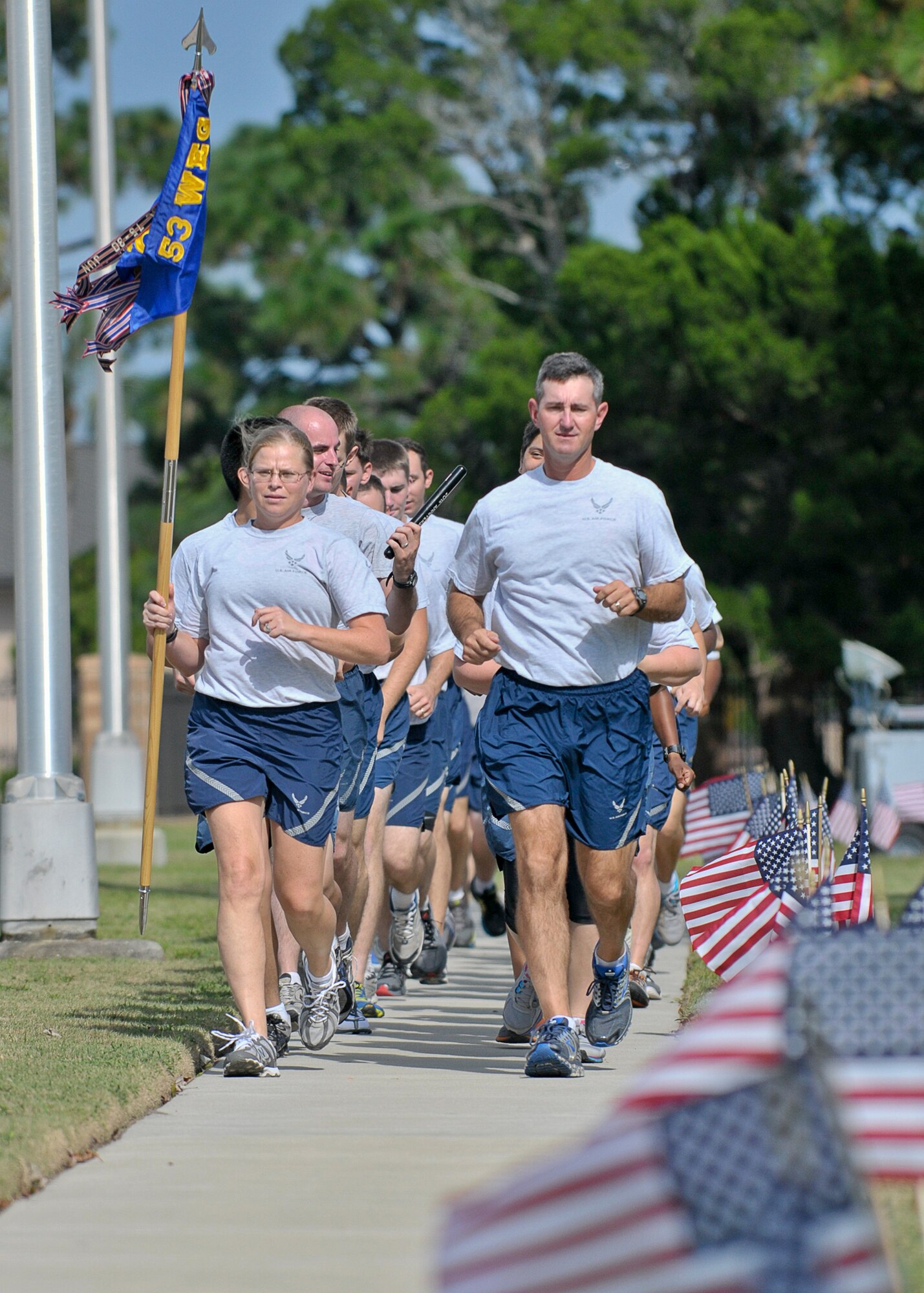 Lieutenant Colonel Bruce Bunce, 81st Range Control Squadron commander (right) and Master Sgt. Sara Anema, 81st RCS superintendent (left), lead a group of Airmen from the 81st RCS during the last laps of the 24-hour Prisoners of War Missing in Action vigil run, at Tyndall Air Force Base Sept.20. (U.S. Air Force photo by Staff Sgt. Javier Cruz) 