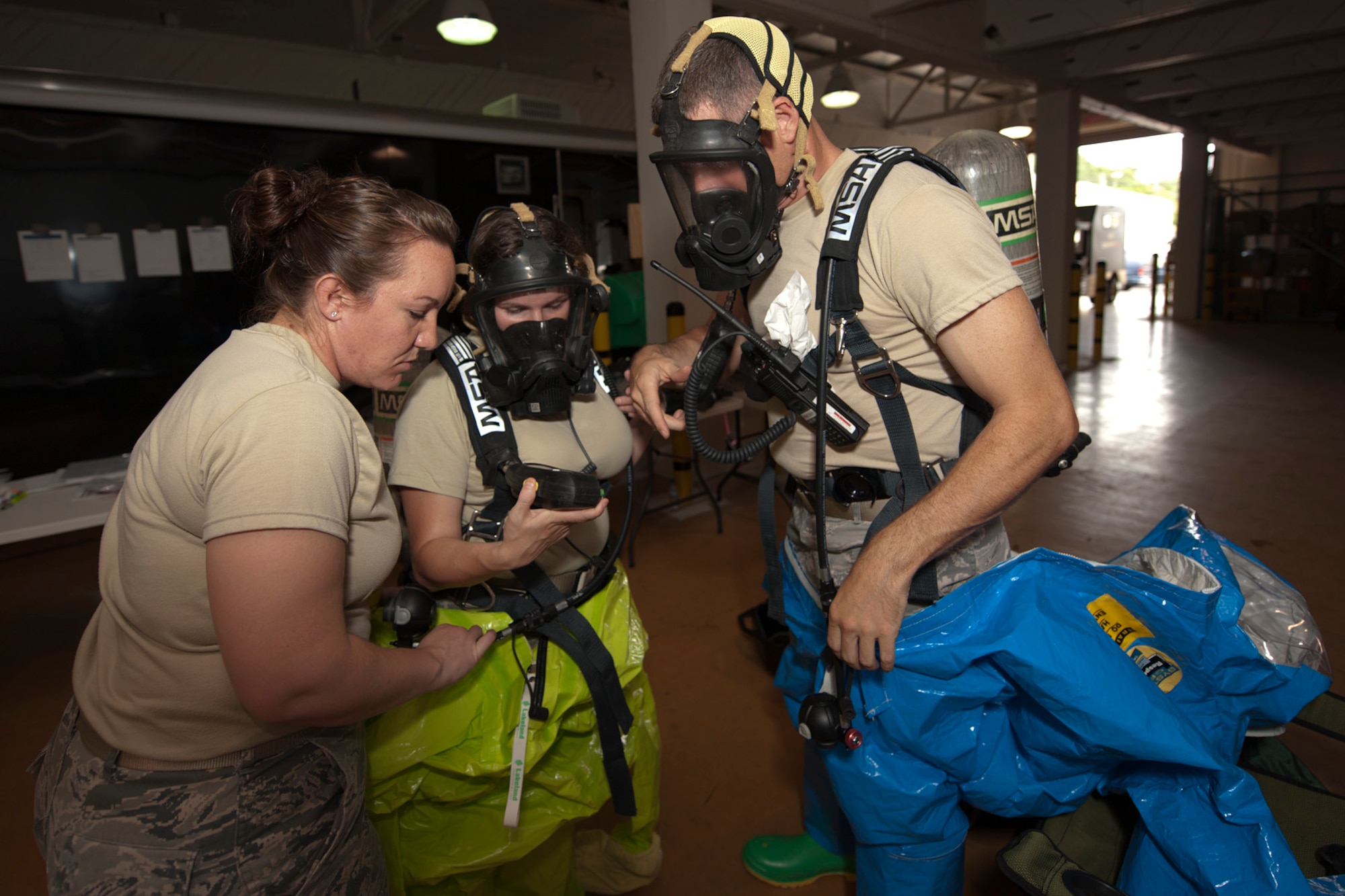 U.S. Air Force Staff Sgt. Sarah Carr, 65th Medical Operations Squadron bioenvironmental engineering craftsman, Senior Airman Devon de Castrique, 65th MDOS environmental health manager, and Staff Sgt. Samuel Helfrich, 65th Civil Engineer Squadron emergency management technician, perform function tests of their breathing apparatus during a joint biological response training exercise Sept. 20, 2013, at Lajes Field, Azores. The exercise is to test the effectiveness of emergency managers and bioenvironmental engineers working together in a crisis situation, maintain proficiency in duties, and identify strength or improvement capabilities. Carr, a Robinson, Ill., native, is the Occupational Health non-commissioned officer in charge. De Castrique is from Charlotte, N.C., and Helfrich is from San Clemente, Calif. (U.S. Air Force photo by Tech. Sgt. Paul Villanueva II/Released)