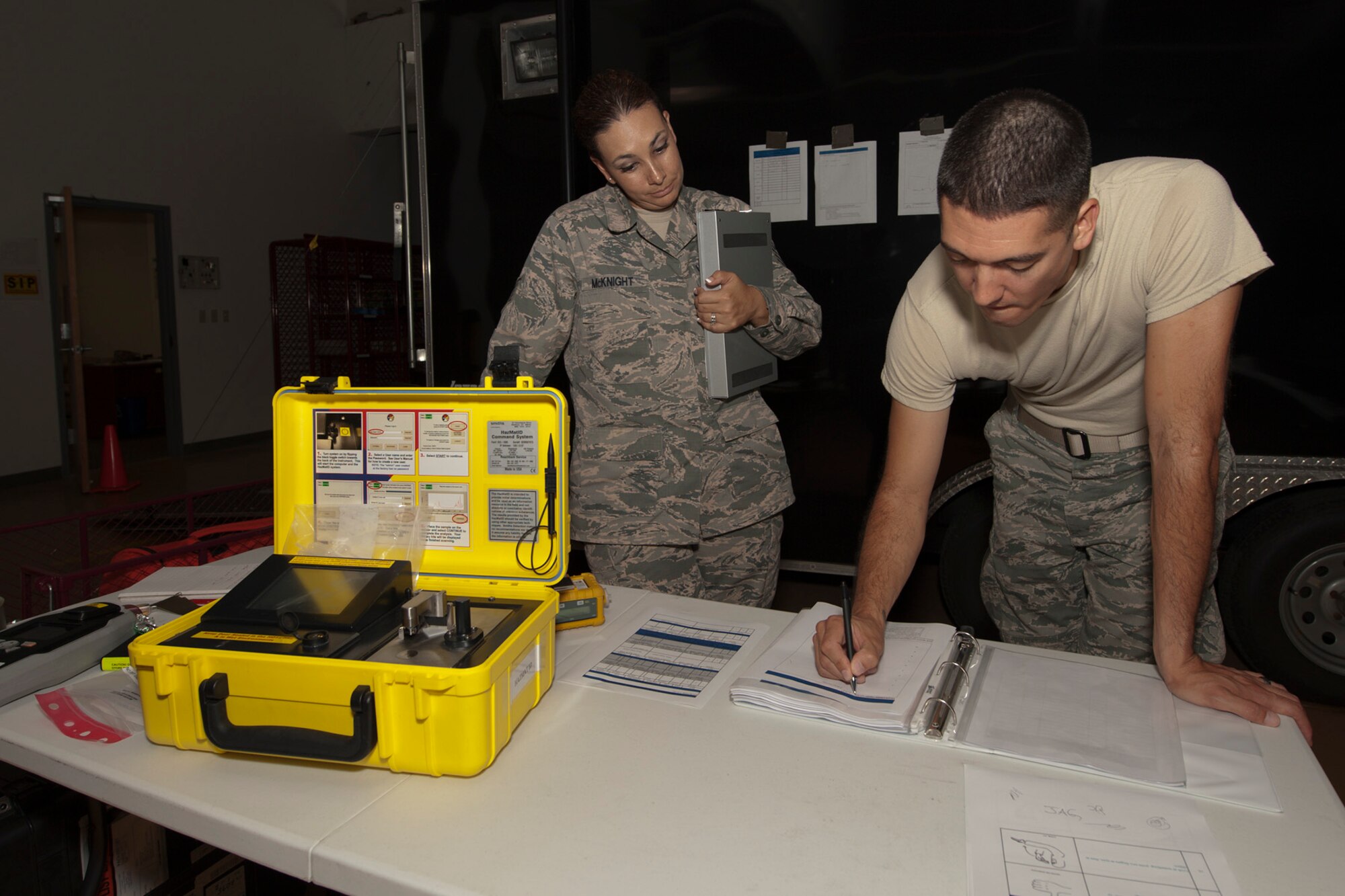 U.S. Air Force Tech. Sgt. Ninfa McKnight, 65th Medical Operations Squadron Bioenvironmental Engineering flight chief, and Staff Sgt. James Goeddey, 65th Civil Engineer Squadron Plans and Operations non-commissioned officer in charge, discuss the actions to be taken during the joint biological response training exercise Sept. 20, 2013, at Lajes Field, Azores. The exercise is to test the effectiveness of emergency managers and bioenvironmental engineers working together in a crisis situation, maintain proficiency in duties, and identify strength or improvement capabilities. McKnight is a native of Northridge, Calif., and Goeddey is a native of Tacoma, Wash. (U.S. Air Force photo by Tech. Sgt. Paul Villanueva II/Released)
