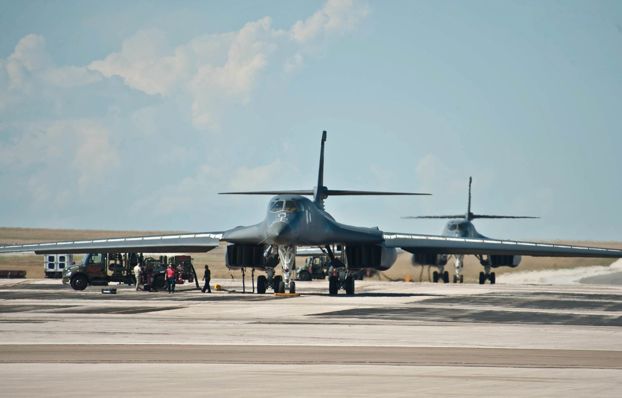 Airman assigned to the 28th Logistics Readiness Squadron petroleum oil and lubricants section fuel B-1 bombers during hot pit refueling at Ellsworth Air Force Base, S.D., Sept. 17, 2013. Hot pit refueling is designed to rapidly refuel running aircraft  – resulting in faster aircraft regeneration. (U.S. Air Force photo by Airman 1st Class Zachary Hada/Released)