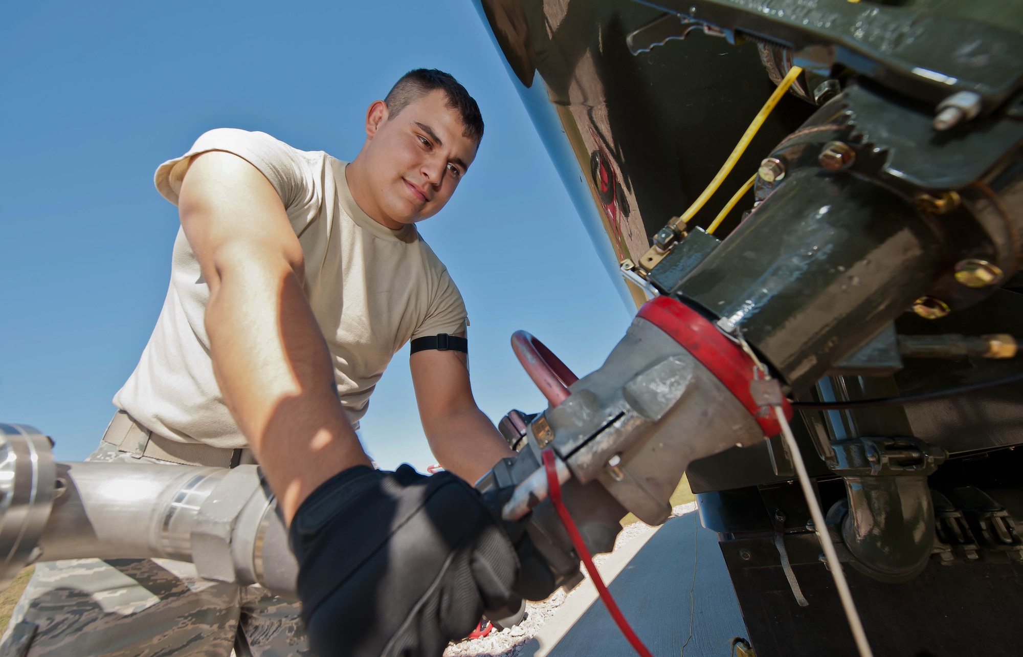 Airman 1st Class Antonio Herrera, 28th Logistics Readiness Squadron petroleum oil and lubricants technician, fills up an R-11 fuel tank truck with jet fuel at Ellsworth Air Force Base, S.D., Sept. 17, 2013. The 28th LRS fuels flight produces more than 18 million gallons of quality petroleum products and cryogenic fluids annually for base assets. (U.S. Air Force photo by Airman 1st Class Zachary Hada/Released)