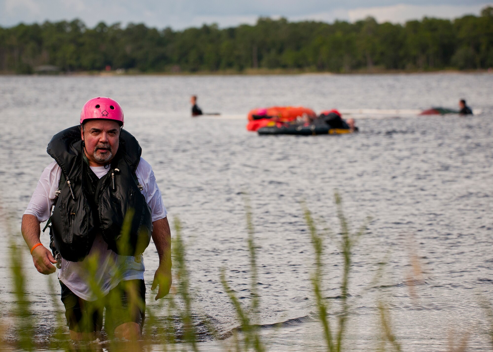 Mario Mardones, 96th Civil Engineer Squadron, exits the water after experiencing the 96th Test Wing’s honorary commanders’ aircrew water survival orientation at Eglin Air Force Base, Fla., Sept. 23.  Designed for training pilots in the use of water survival equipment after an ejection over the sea or an emergency landing, the exercises provide an interactive environment for community members to work with Airmen. The honorary commander program pairs civic leaders and wing leadership together to exchange ideas and educate civilians about Air Force life. (U.S. Air Force photo/Samuel King Jr.)