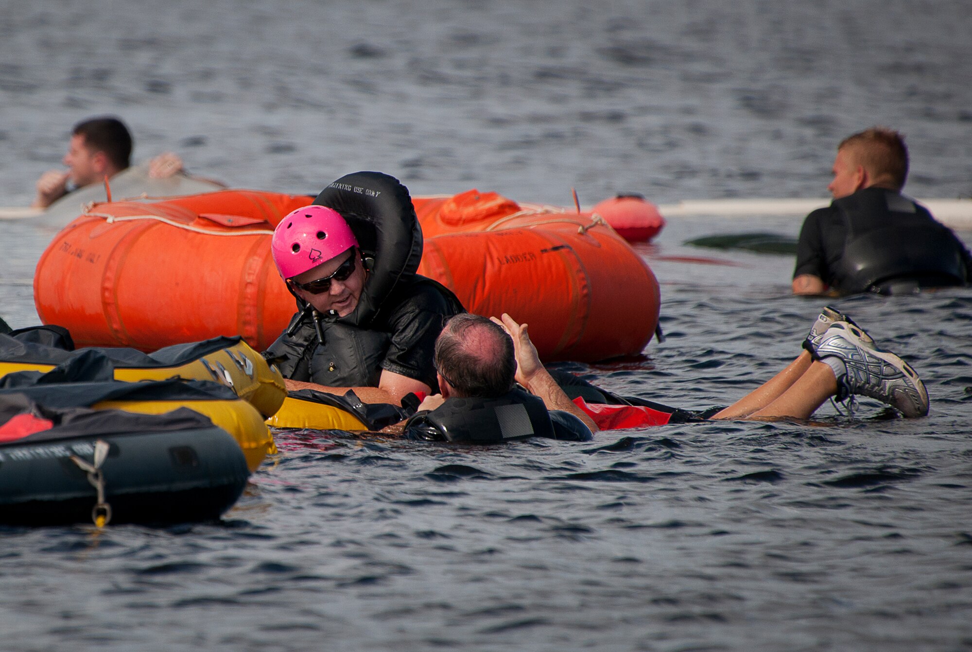 Lee Lewis, 40th Flight Test Squadron, hangs onto a flotation device as he listens to Bill Talton, 96th Operations Support Squadron aircrew flight equipment, explain techniques and procedures for aircrew water survival during the 96th Test Wing’s honorary commander orientation at Eglin Air Force Base, Fla., Sept. 23.  Designed for training pilots in the use of water survival equipment after an ejection over the sea or an emergency landing, the exercises provide an interactive environment for community members to work with Airmen. The honorary commander program pairs civic leaders and wing leadership together to exchange ideas and educate civilians about Air Force life. (U.S. Air Force photo/Samuel King Jr.)