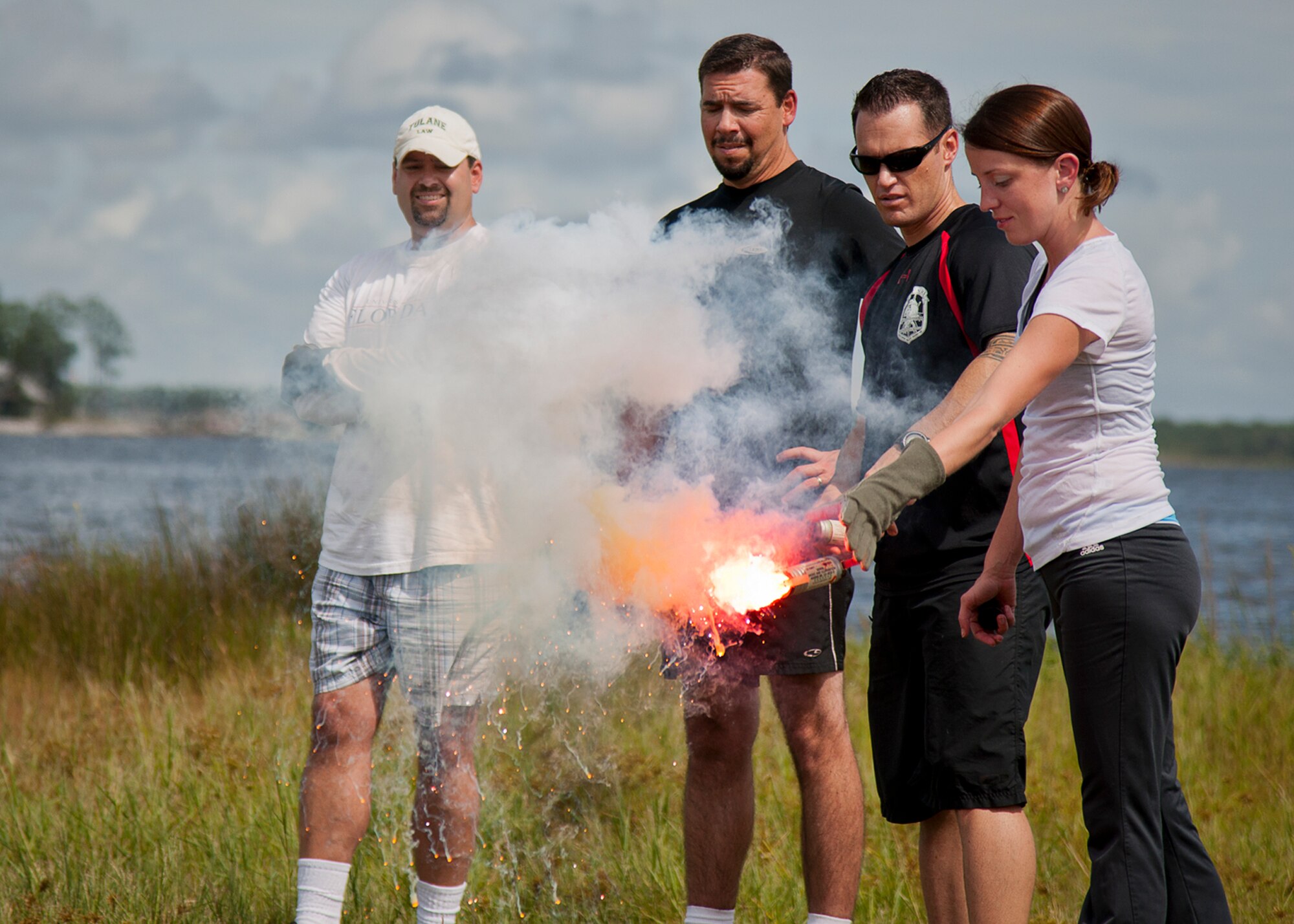 Jessica Driver, 96th Maintenance Squadron, and other 96th Test Wing honorary commanders pop flares during their aircrew water survival orientation at Eglin Air Force Base, Fla., Sept. 23.  Designed for training pilots in the use of water survival equipment after an ejection over the sea or an emergency landing, the exercises provide an interactive environment for community members to work with Airmen. The honorary commander program pairs civic leaders and wing leadership together to exchange ideas and educate civilians about Air Force life. (U.S. Air Force photo/Samuel King Jr.)