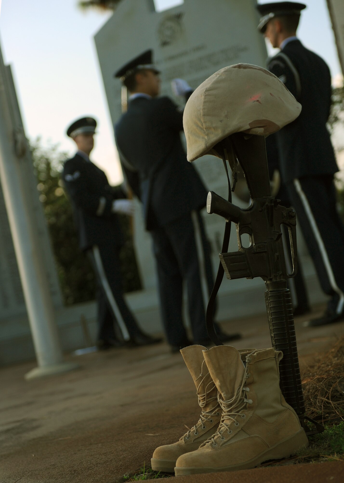 The Battle Field Cross is among the last items gathered by the Hurlburt Field Honor Guard at the conclusion of the Prisoner of War/Missing in Action Recognition Day ceremony at the air park on Hurlburt Field, Fla. Sept. 20, 2013. The cross, composed of boots, a downward facing rifle and helmet, are used to memorialize fallen service members.  (U.S. Air Force photo/Senior Airman Kentavist P. Brackin)