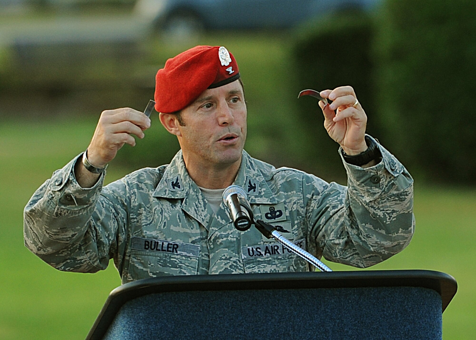 Col. Kurt. Buller, 720th Special Tactics Group commander, shows Air Commandos his broken Prisoner of War/Missing in Action bracelet during a POW/MIA Recognition Day ceremony at the air park on Hurlburt Field, Fla., Sept. 20, 2013. Buller’s bracelet displays the name, Scott Speicher, who was a Navy pilot shot down during the Persian Gulf War. His remains weren't discovered until Aug. 2, 2009. (U.S. Air Force photo/Senior Airman Kentavist P. Brackin)
