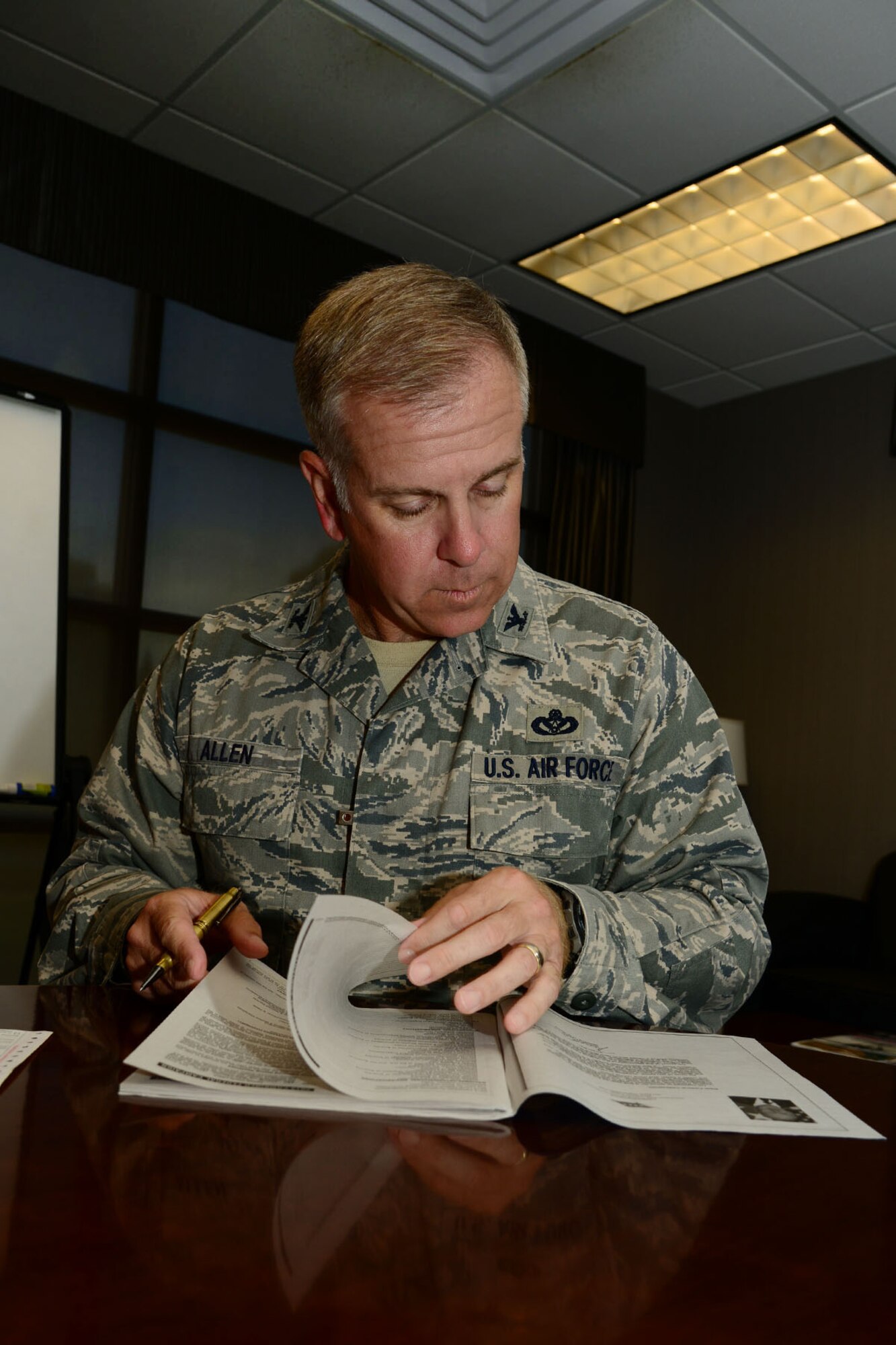U.S. Air Force Col. John J. Allen Jr., 633rd Air Base Wing commander, looks through the Combined Federal Campaign charity catalog at Langley Air Force Base, Va., Sept. 23, 2013. The 2013 CFC officially began Sept. 23 and will last through Nov. 1, with a goal of $193,000. (U.S. Air Force photo by Staff Sgt. Ashley Hawkins/Released)