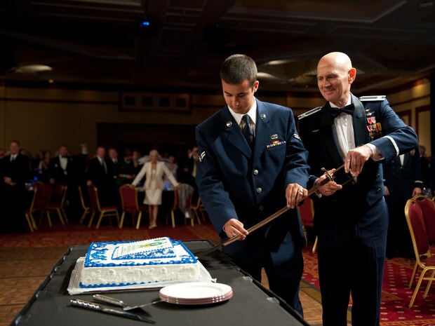 Retired U.S. Air Force Col. James Ruffer and Airman 1st Class Collin Reaves, 757th Aircraft Maintenance Squadron A-10 Thunderbolt II crew chief, cut the Air Force birthday cake during the Air Force Ball Sept. 21, 2013, at South Point Casino in Las Vegas. It is tradition for the oldest and youngest Airmen in attendance to make the ceremonial first cut of the cake. (U.S. Air Force photo by Airman 1st Class Thomas Spangler)