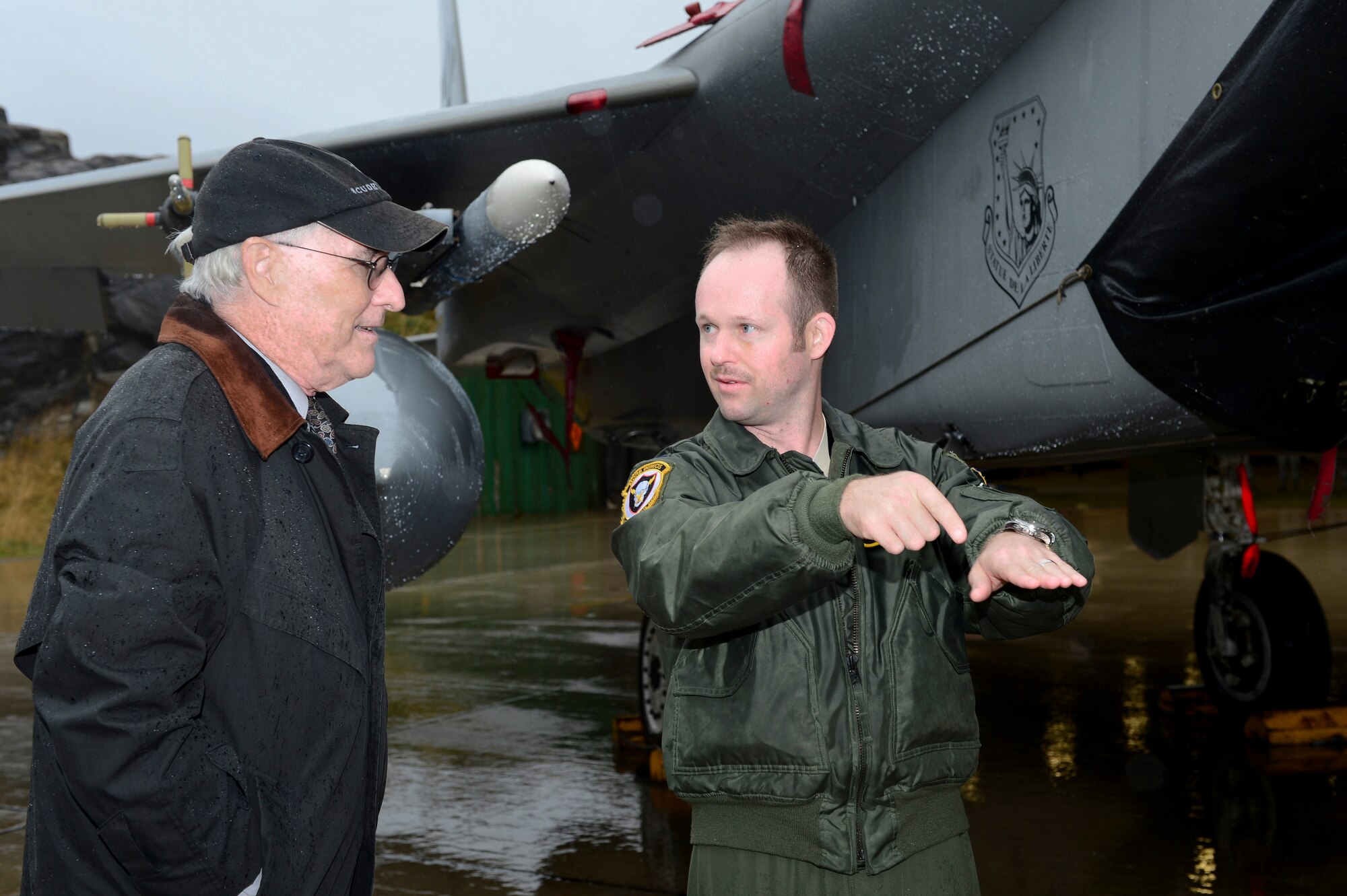 Capt. Nicholas Szala, 493rd Fighter Squadron pilot, explains the capabilities of the F-15C Eagle to U.S. Ambassador to Norway Barry White during his visit to Bodø Main Air Station, Norway, Sept. 20, 2013. White met with leaders and personnel from the United States, Norway, Finland and Sweden on station in support of Arctic Challenge Exercise 2013. ACE-13 is a combined exercise, with NATO allies and regional partners that provides an opportunity for all forces to integrate operations and build upon our international relationships. Approximately 30 aircraft and 600 personnel deployed from RAFs Lakenheath and Mildenhall in support of ACE-13. (U.S. Air Force photo by Master Sgt. Lee Osberry/Released)