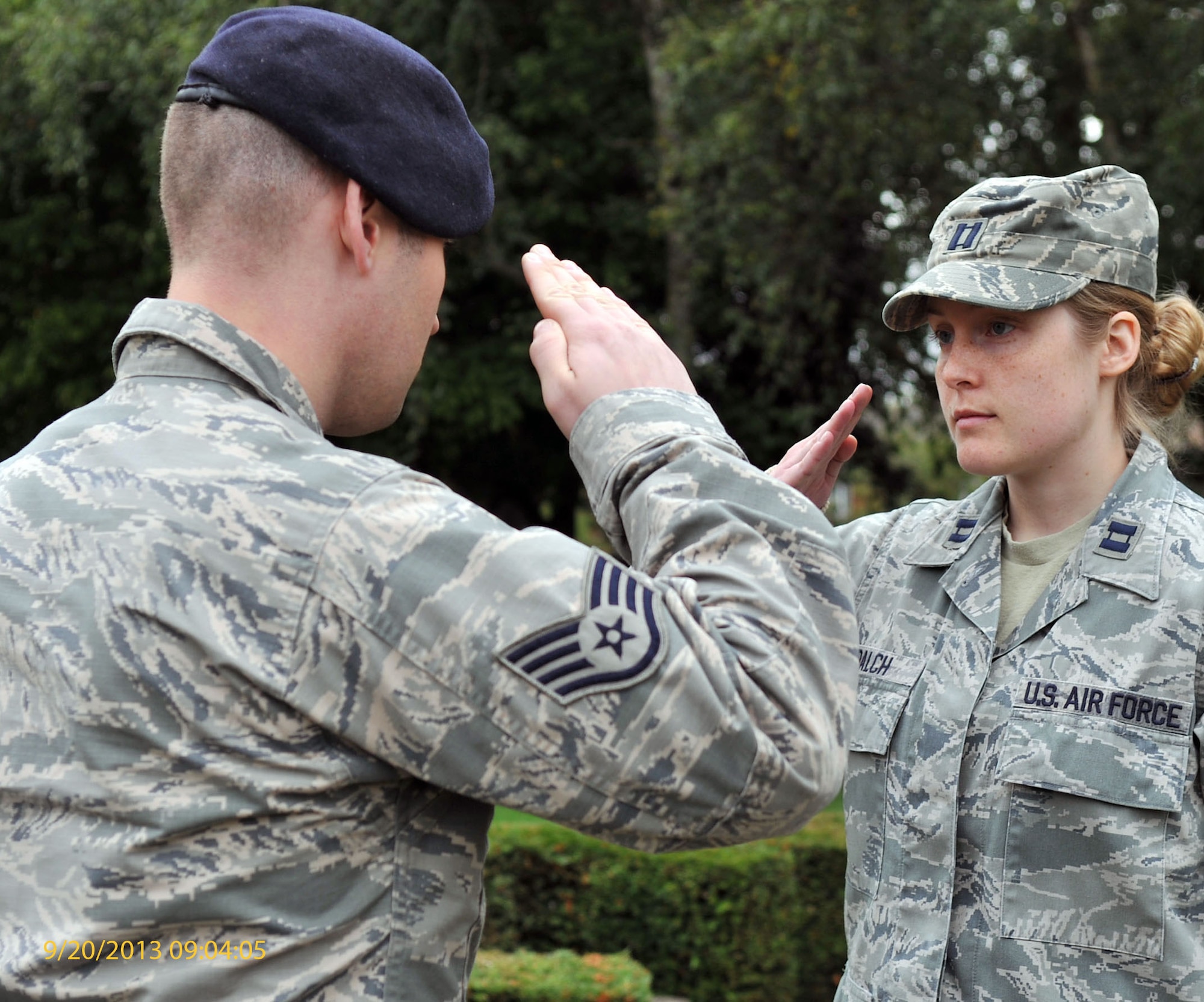 U.S. Air Force Capt. Laura Balch, right, 100th Air Refueling Wing Public Affairs chief, renders a salute as she’s relieved by another Team Mildenhall member during a 24-hour POW/MIA vigil Sept. 20, 2013, on RAF Mildenhall, England. Team Mildenhall members continually rotated reading names and standing at parade rest to guard the POW/MIA monument for 24 hours to honor POW/MIA service members. The vigil ended with a retreat ceremony in remembrance of POW/MIAs. (U.S. Air Force photo by Airman 1st Class Kyla Gifford/Released)