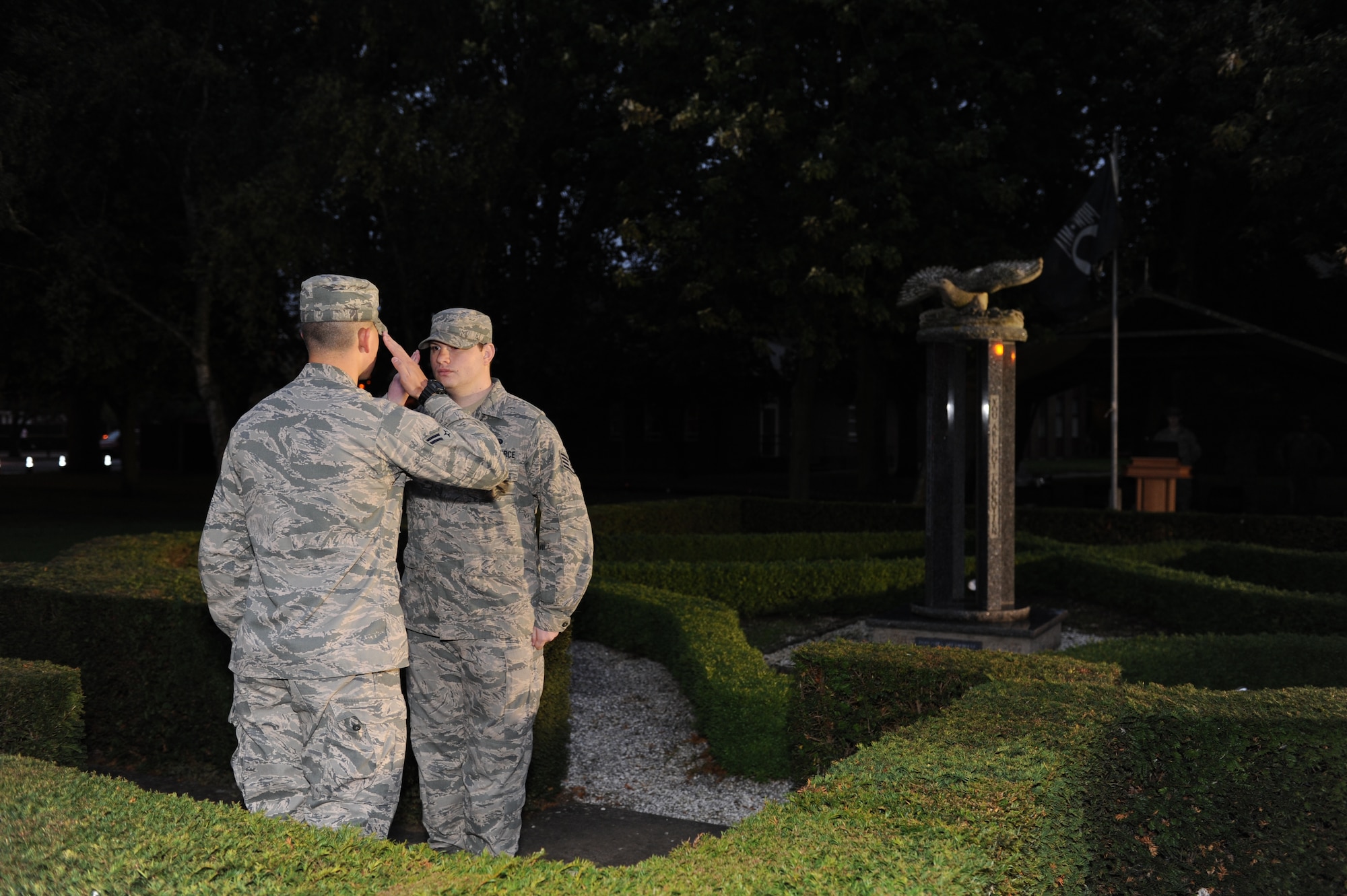 Team Mildenhall Airmen render salutes as one Airman relieves another during a POW/MIA vigil Sept. 19, 2013, on RAF Mildenhall, England. The vigil was held for 24 hours, with Airmen reciting the names of POW/MIA service members during the entire ceremony. Part of POW/MIA remembrance week, the vigil honored those who have not returned home. (U.S. Air Force photo by Airman 1st Class Preston Webb/Released)
