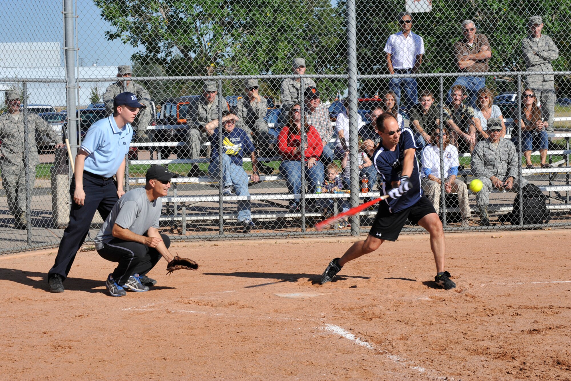 PETERSON AIR FORCE BASE, Colo. – Col. John Shaw, 21st Space Wing commander, drives a softball into the outfield during the Space World Series Sept. 20. The 21st Space Wing Chiefs and Eagles softball team competed against the 50th Space Wing Chiefs and Eagles softball team. Team 2-1 defeated Team 5-0 with a final score of 21-15. (U.S. Air Force photo/Robb Lingley)