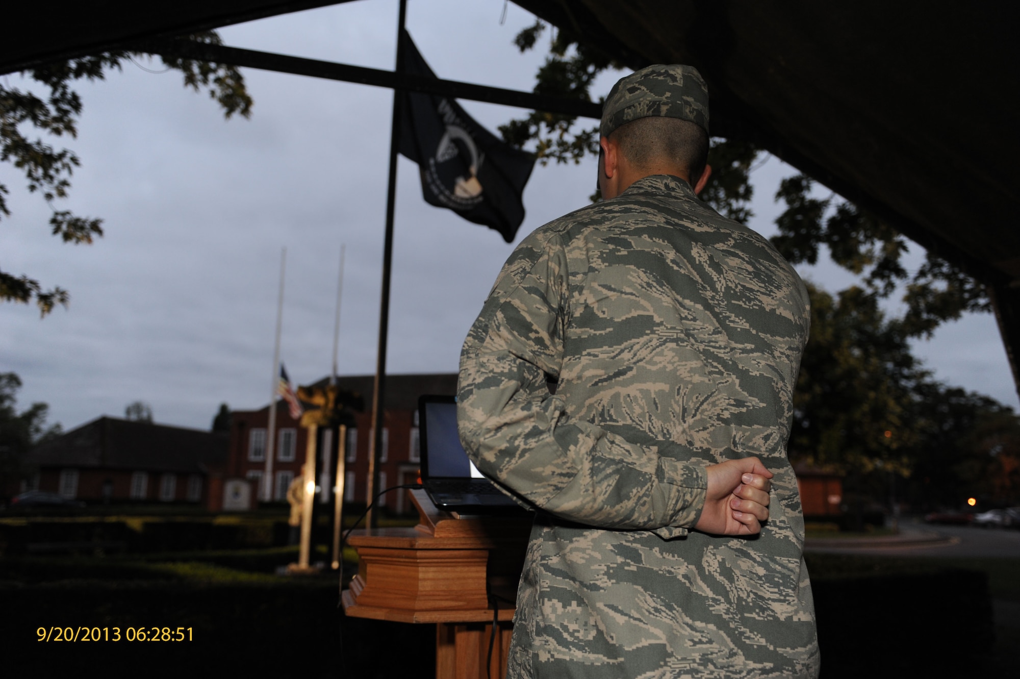 A Team Mildenhall service member reads names of POW/MIAs during a vigil Sept. 20, 2013, on RAF Mildenhall, England. The names were read to honor and remember those who were unable to return home. The vigil ended with a retreat ceremony in remembrance of those honored. (U.S. Air Force photo by Airman 1st Class Preston Webb/Released)