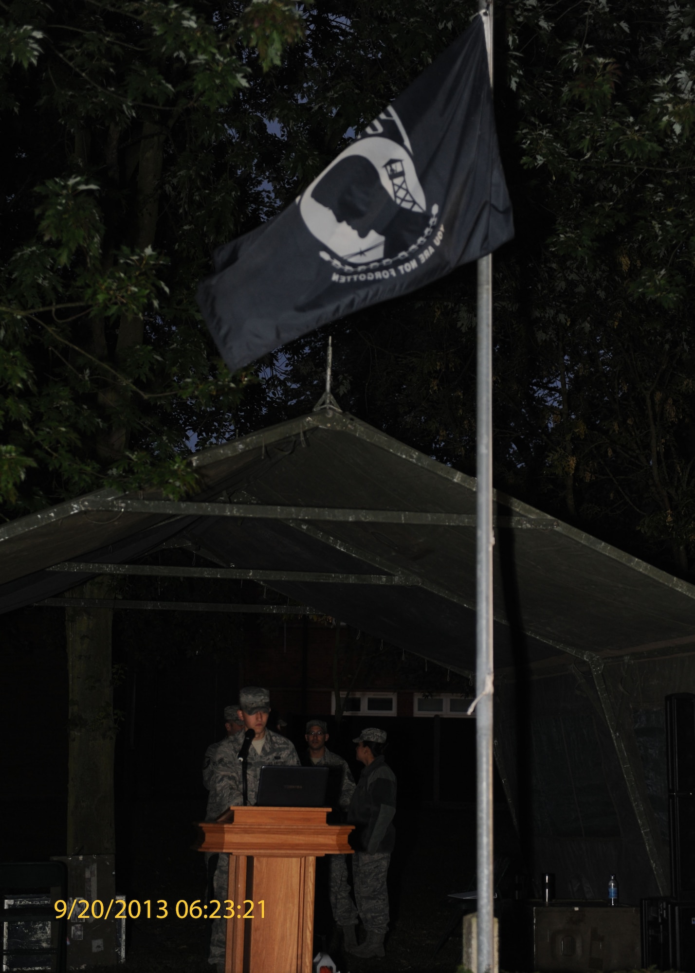 A Team Mildenhall service member reads names of POW/MIAs during a vigil Sept. 20, 2013, on RAF Mildenhall, England. The names were read to honor and remember those who were unable to return home. The vigil ended with a retreat ceremony in remembrance of those honored. (U.S. Air Force photo by Airman 1st Class Preston Webb/Released)
