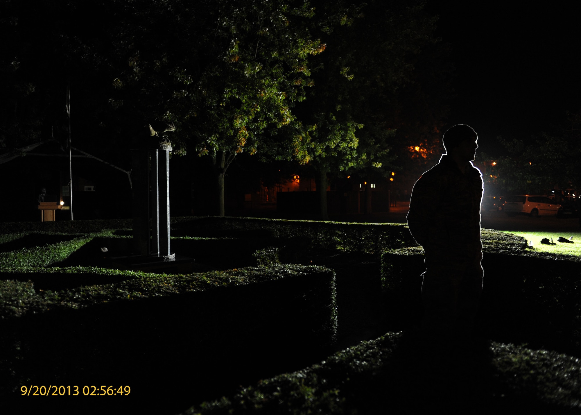 A Team Mildenhall Airman silently stands at parade rest to guard the prisoners POW/MIA monument during a vigil Sept. 20, 2013, on RAF Mildenhall, England. Airmen continually rotated reading names and standing at parade rest for 24 hours to honor POW/MIA service members. Part of POW/MIA remembrance week, the vigil honored those who have not returned home. (U.S. Air Force photo by Airman 1st Class Preston Webb/Released)