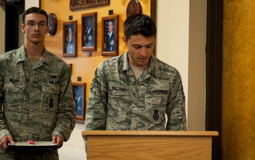 U.S. Air Force Staff Sgt. Donald Williams, 824th Base Defense Squadron fireteam leader, reads a Bronze Star Medal citation at Moody Air Force Base Ga., Sept. 20, 2013. Capt. Brian Bray, 824th intelligence officer, earned the award for meritorious achievement while on deployment in Afghanistan. (U.S. Air Force photo by Airman 1st Class Sandra Marrero/Released)
