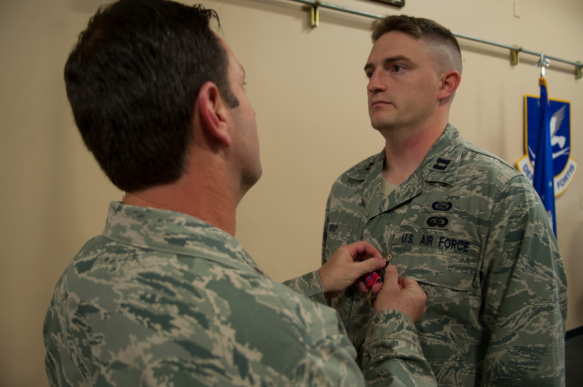 U.S. Air Force Maj. Jeffrey, Spencer, 824th Base Defense Squadron commander, pins a Bronze Star Medal on Capt. Brian Bray, 824th BDS intelligence officer at Moody Air Force Base, Ga., Sept. 20, 2013. The medal is awarded for heroic or meritorious achievement during military operations against an armed enemy. (U.S. Air Force photo by Airman 1st Class Sandra Marrero/Released)
