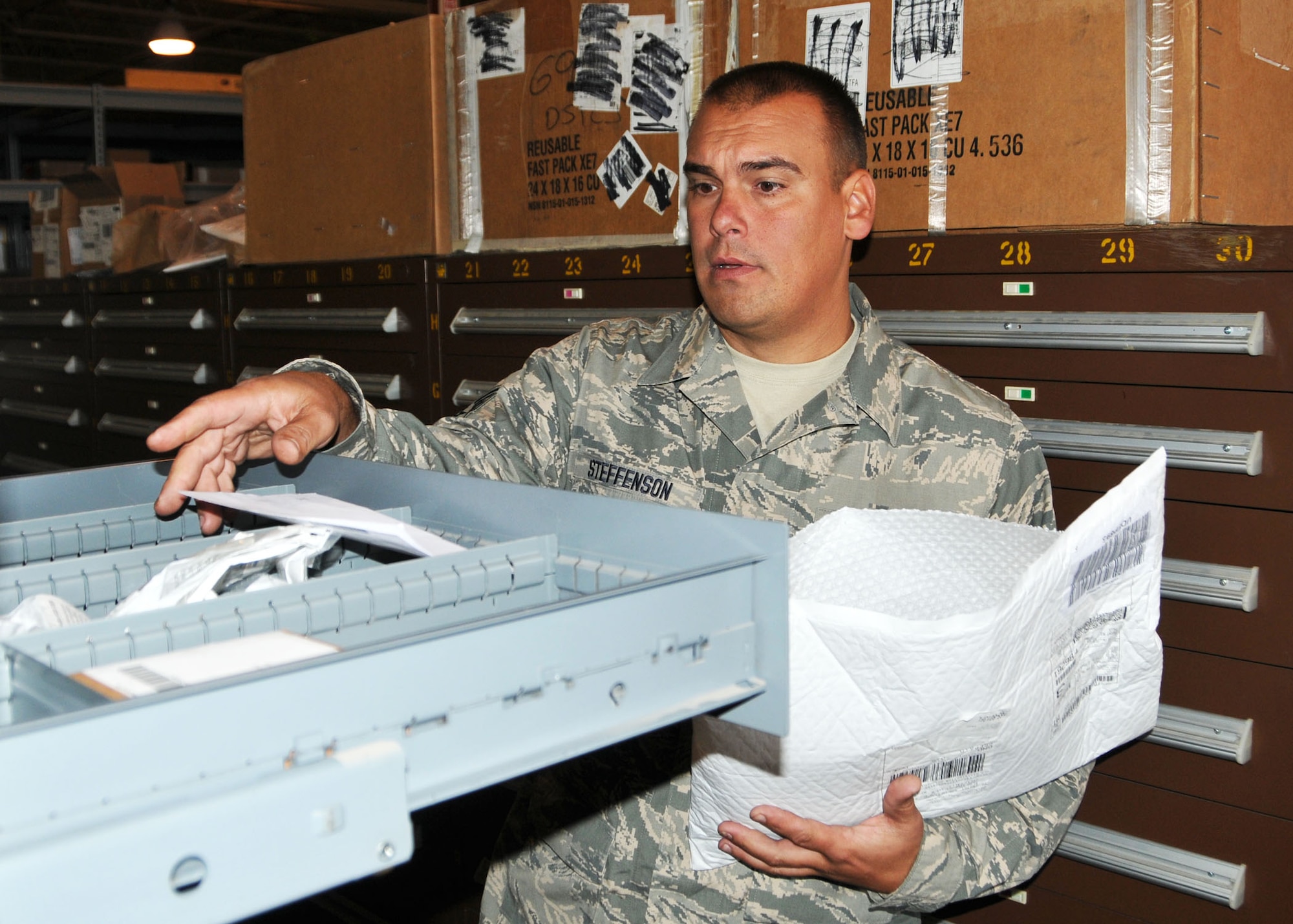 Staff Sgt. James Steffenson, a fuels maintenance specialist with the 120th Fighter Wing in Great Falls, Mont., sorts incoming parts for the 120th Logistics Readiness Squadron. He volunteered to assist the squadron during the wing conversion to the C-130 Hercules air transport mission. National Guard photo/Senior Master Sgt. Eric Peterson.