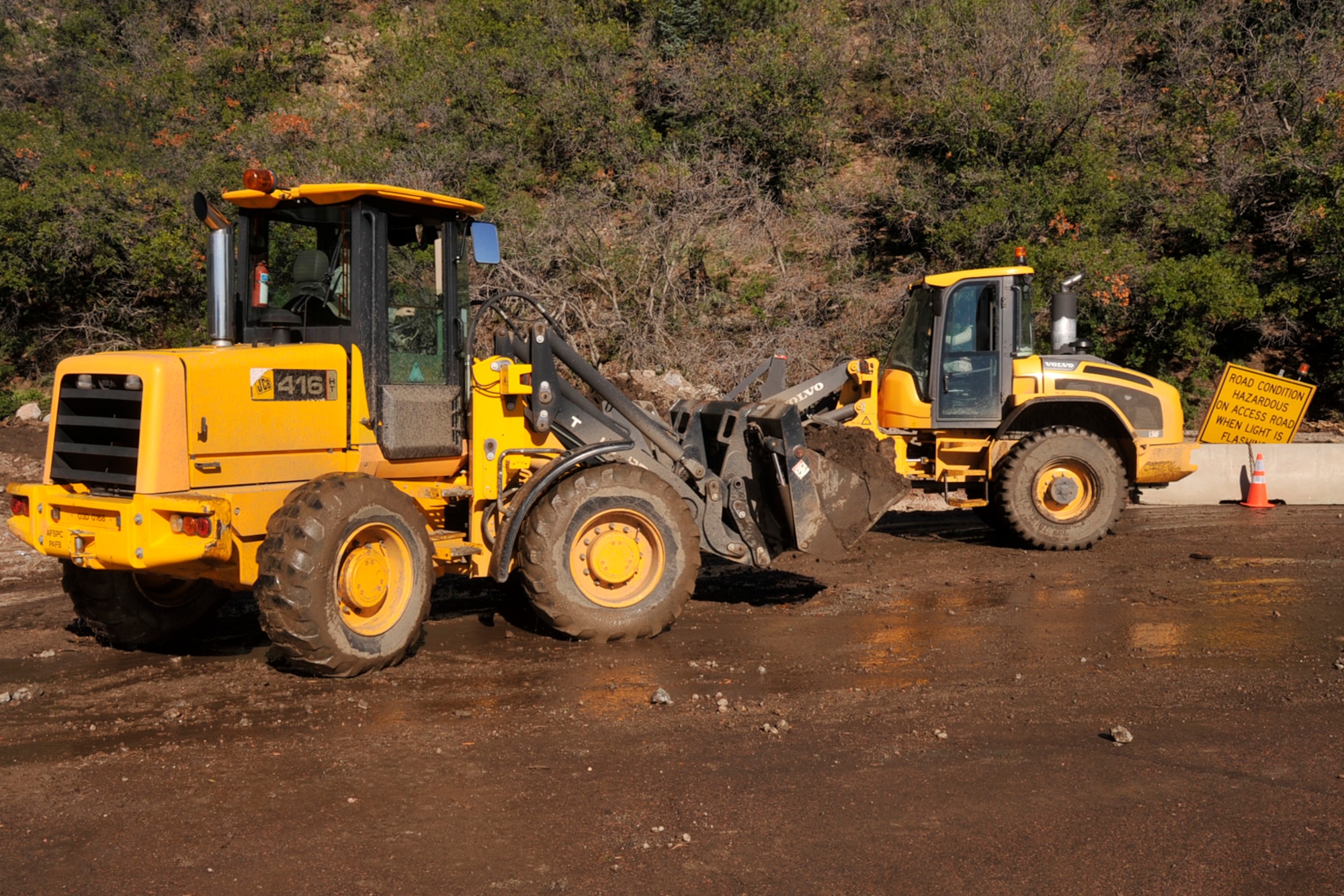 CHEYENNE MOUNTAIN AIR FORCE STATION, Colo. – Airmen from the 21st Civil Engineer Squadron at Peterson AFB work to clear nearly 7,200 cubic yards of debris that collapsed during a rockslide at Cheyenne Mountain Sept. 12. The Airmen from the 21st CES worked hand-in-hand with the CMAFS engineer squadron as well as with Soldiers from Fort Carson who helped clear the debris within a week’s time. (U.S. Air Force Photo/Robb Lingley)