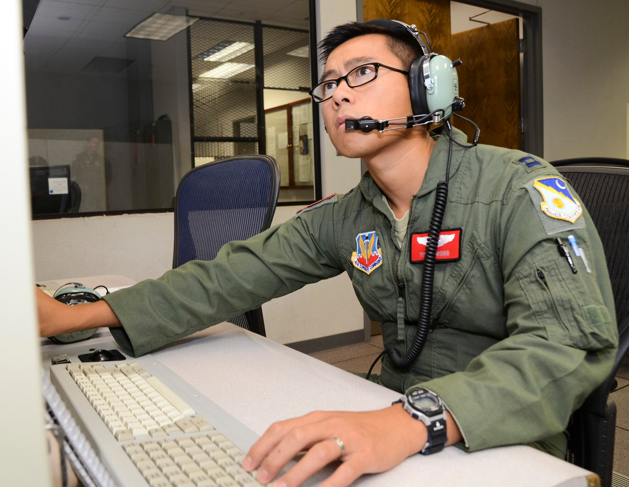 U.S. Air Force Capt. Titus, 16th Airborne Command and Control Squadron senior director, views radar data from a simulated E-8C Joint STARS operator workstation during Coalition Virtual Flag 13-4, Robins Air Force Base, Ga., Sept. 18, 2013. Exercise planners and aviators from the 116th and 461st Air Control wings, participated in the virtual exercise along with units from 23 different locations worldwide including Australia, Canada and the United Kingdom. Team JSTARS provided command and control, intelligence, surveillance and reconnaissance in both land and maritime environments during the exercise. (U.S. Air National Guard photo by Master Sgt. Roger Parsons/Released) (Portions of the photo have been blurred and the full name of the aviator has been withheld for security purposes)