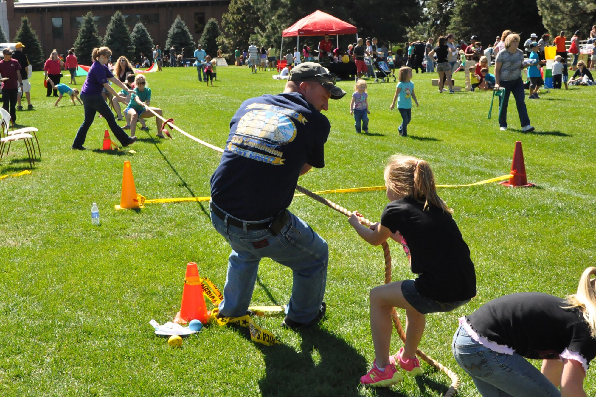 PETERSON AIR FORCE BASE, Colo. - Peterson families play tug-of-war during the Worldwide Day of Play at Patriot Park Sept. 21. The event was hosted by the 21st Force Support Squadron and included a mechanical bull, bounce house and slide, a football throw, climbing wall, car show and more. The goal of the Worldwide Day of Play is to encourage children to get outside and play. (U.S. Air Force photo/Tech. Sgt. Jared Marquis)
