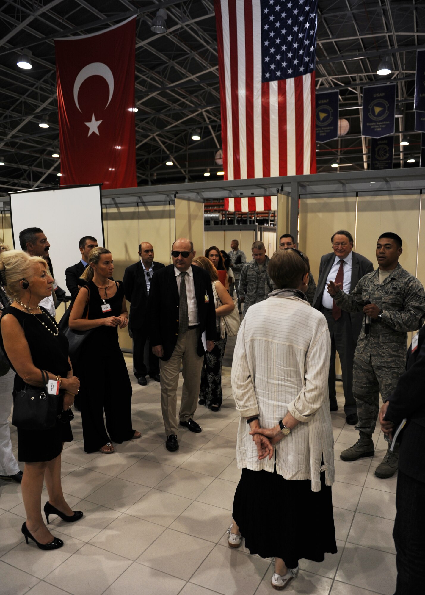 Airman 1st Class Steven Lacefield, 39th Logistics Readiness Squadron logistics plans apprentice, briefs members of the NATO Parliamentary Assembly on the capacity and facilities available in the LRS Reception Facility Sept. 24, 2013 at Incirlik Air Base, Turkey. The LRS Reception Facility is designed to facilitate speedy deployment to and evacuation from Incirlik AB. (U.S. Air Force photo by Senior Airman Chase Hedrick/Released)