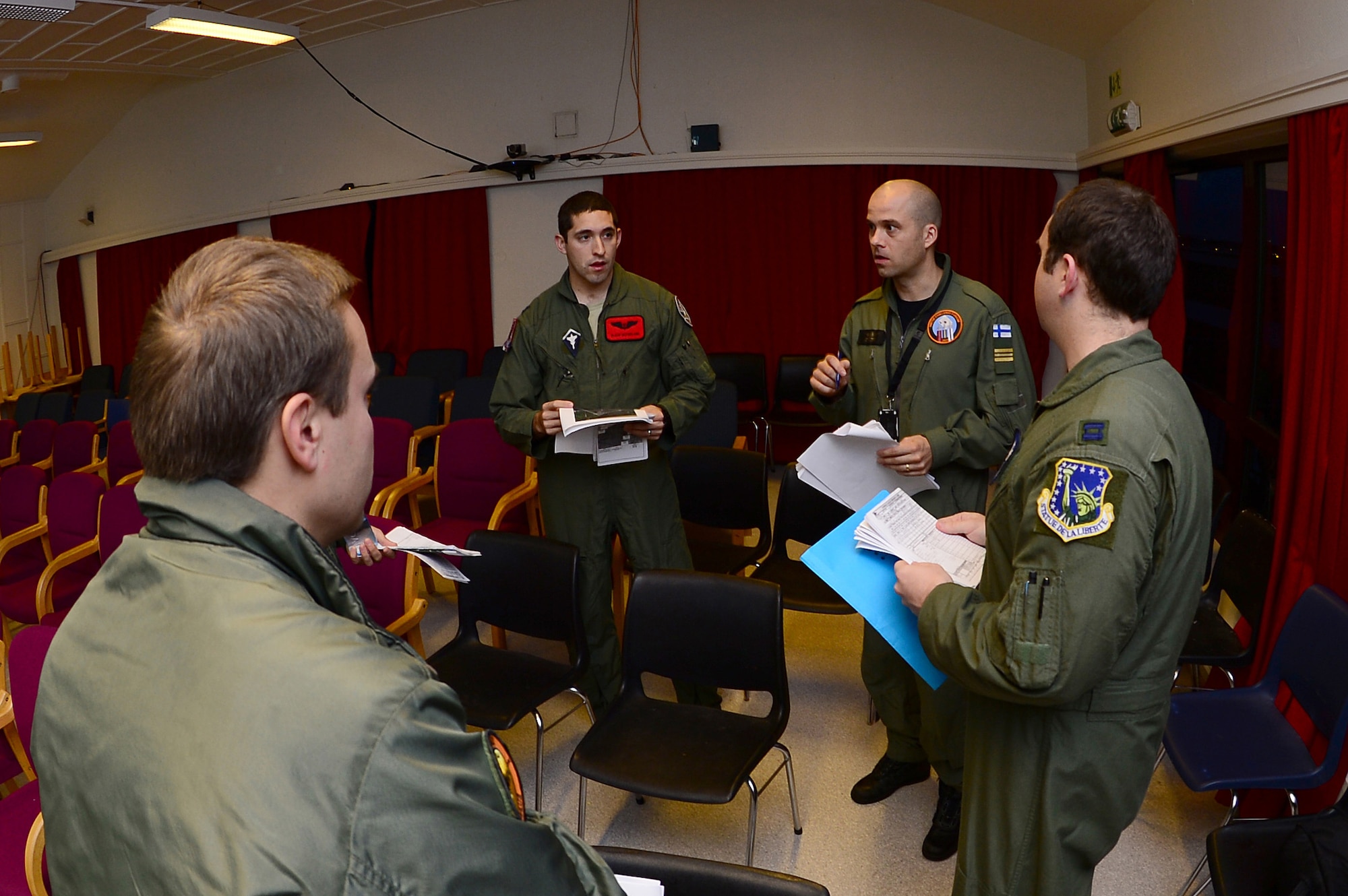 U.S., Finnish and Swedish aircrew members discuss flight operations at Bodø Main Air Station, Norway, Sept. 23, 2013. The members are on station in support of the Arctic Challenge exercise 2013 (ACE-13). ACE-13 is a combined exercise with NATO allies and regional partners, which promotes continued interoperability between the U.S., Norway, Sweden and Finland. (U.S. Air Force photo by Master Sgt. Lee Osberry/Released)