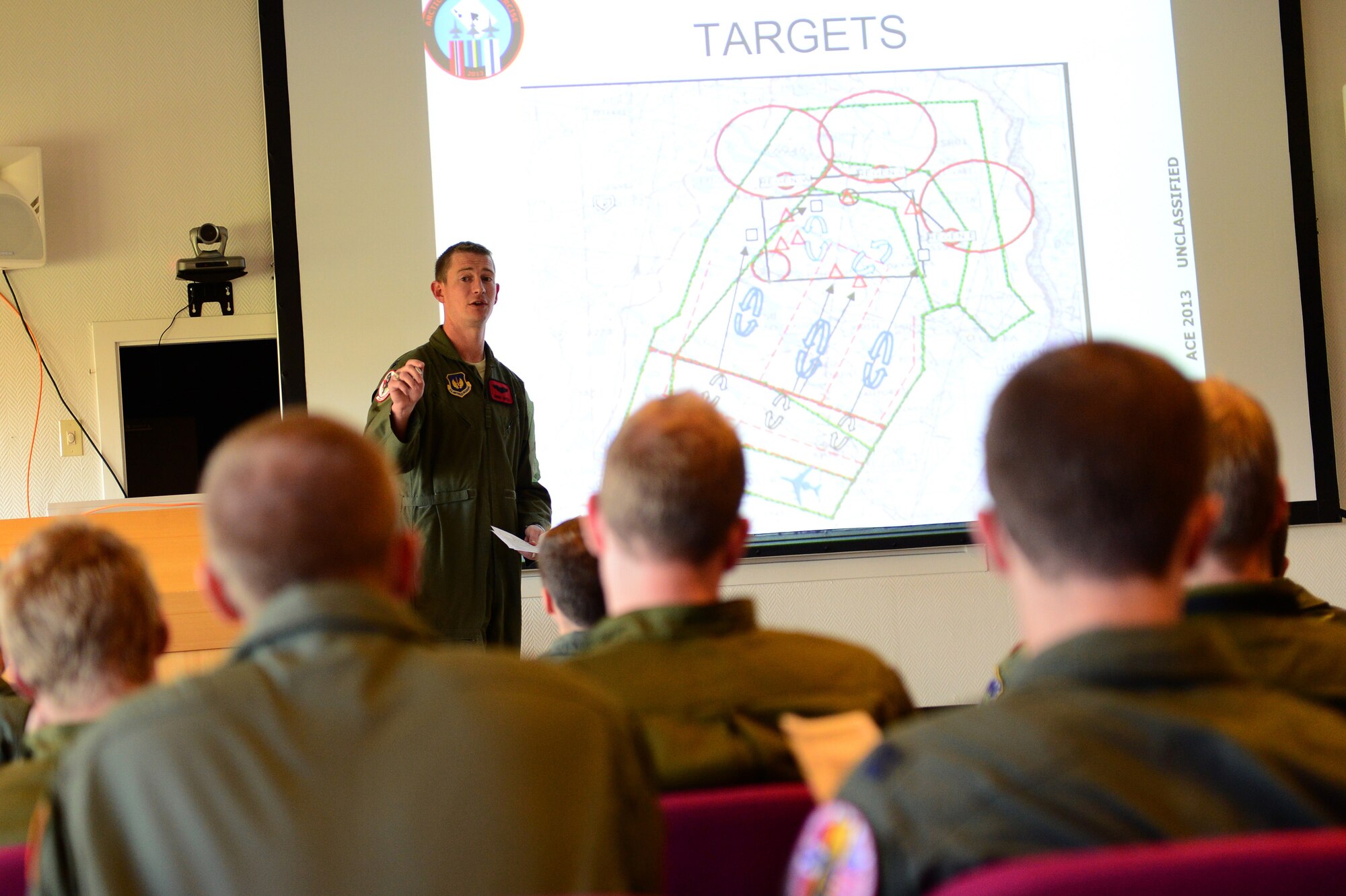 Capt. Johnny Hutto, 494th Fighter Squadron chief of weapons, briefs aircrew members on operations at Bodø Main Air Station, Norway, Sept. 23, 2013. Hutto is amongst approximately 600 personnel deployed, from multiple bases within U.S. Air Forces in Europe-Air Forces Africa, in support of the Arctic Challenge exercise 2013 (ACE-13). ACE-13 is a combined exercise with NATO allies and regional partners, which promotes continued interoperability between the United States, Norway, Sweden and Finland. (U.S. Air Force photo by Master Sgt. Lee Osberry/Released)