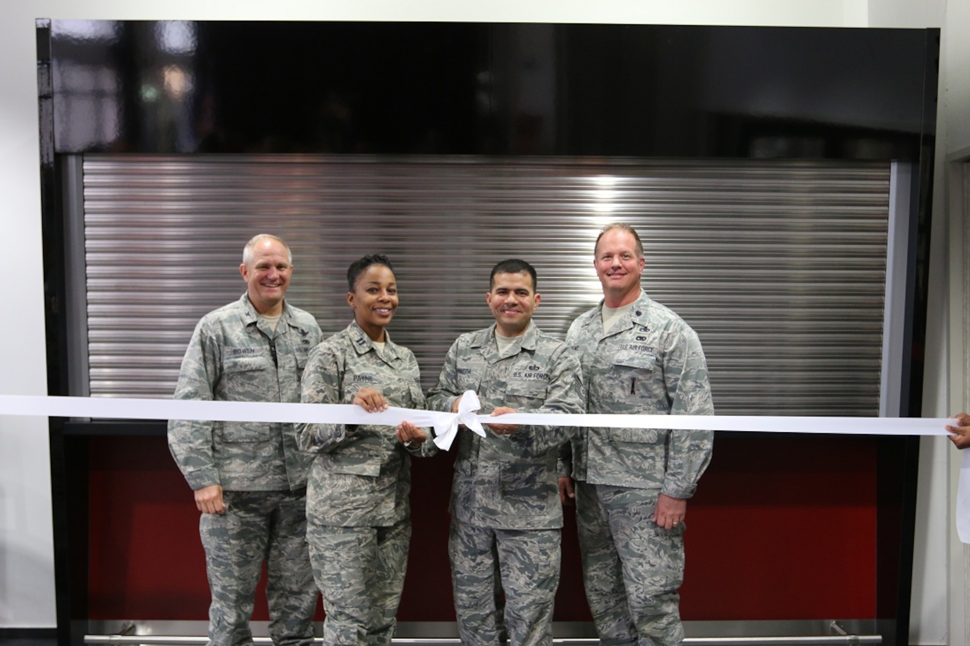 BUECHEL AIR BASE, Germany-- Col. Mark E. Bowen, 52nd Munitions Maintenance Group commander, stands with other leaders during the grand re-opening ribbon cutting ceremony of the Tornado Tavern Club at Beuchel Air Base, Germany.