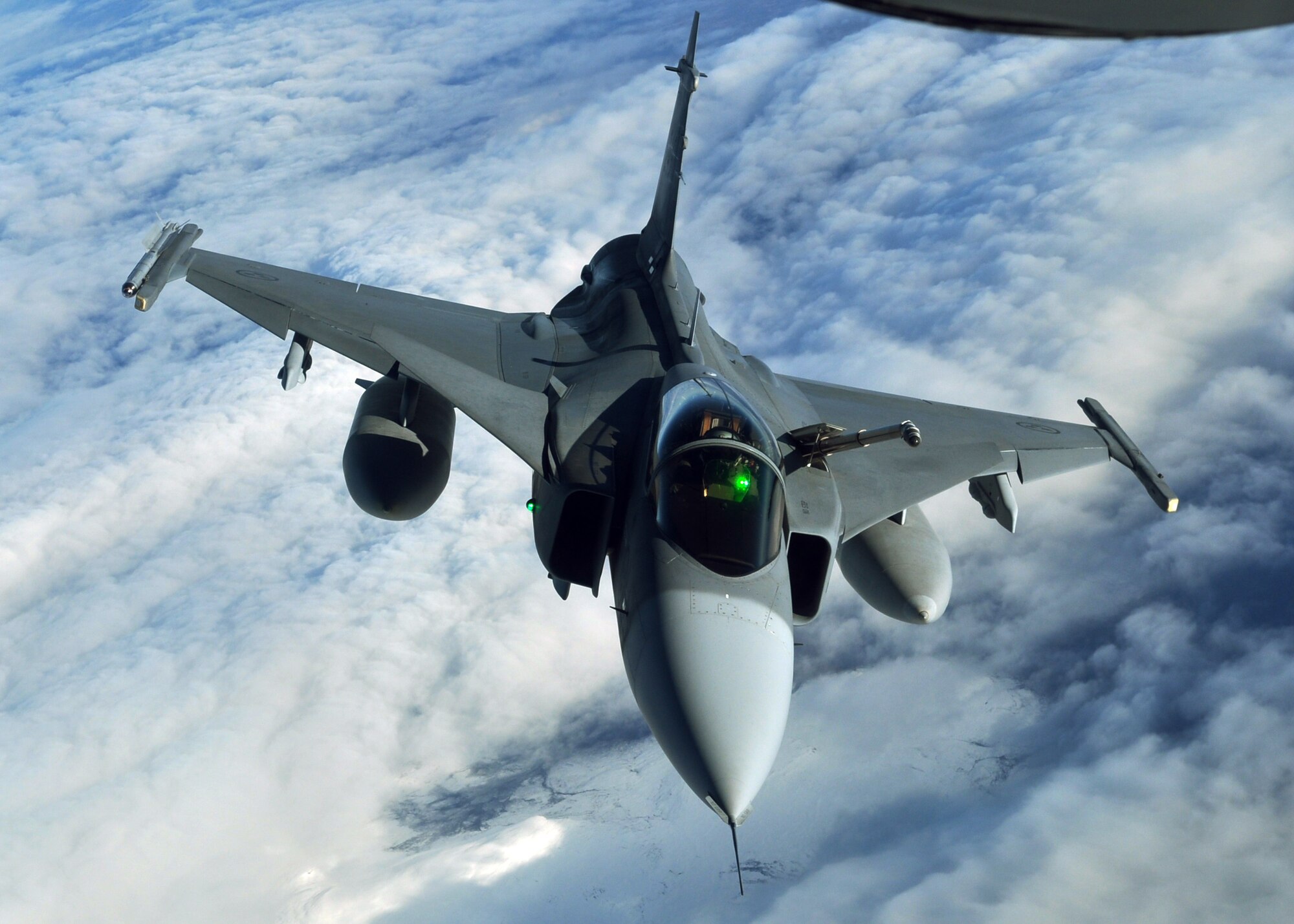 A Swedish JAS-39 Gripen returns to the "play areas" of the Arctic Challenge exercise Sept. 24, 2013, over Norway, after taking fuel from a U.S. Air Force KC-135R Stratotanker. The JAS-39, in coordination with aircraft from other nations, formed a Blue Assault Force, which had to bypass or neutralize an opposing Red Force attempting to stop them from an overall objective outlined in the day’s scenario. (U.S. Air Force photo by 1st Lt. Christopher Mesnard/Released) 