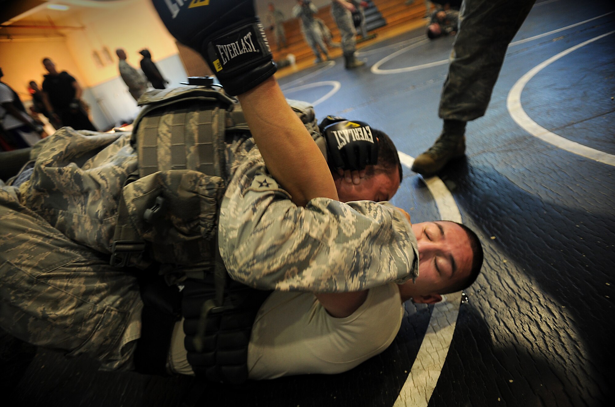 Senior Airman Joel Barajas, 51st Security Forces Squadron area supervisor, grapples with another 51st SFS member during a combatives course at Osan Air Base, Republic of Korea, Sept. 18, 2013. The course is designed to instill confidence and help the defenders think and react under pressure. (U.S. Air Force photo/Staff Sgt. Sara Csurilla)